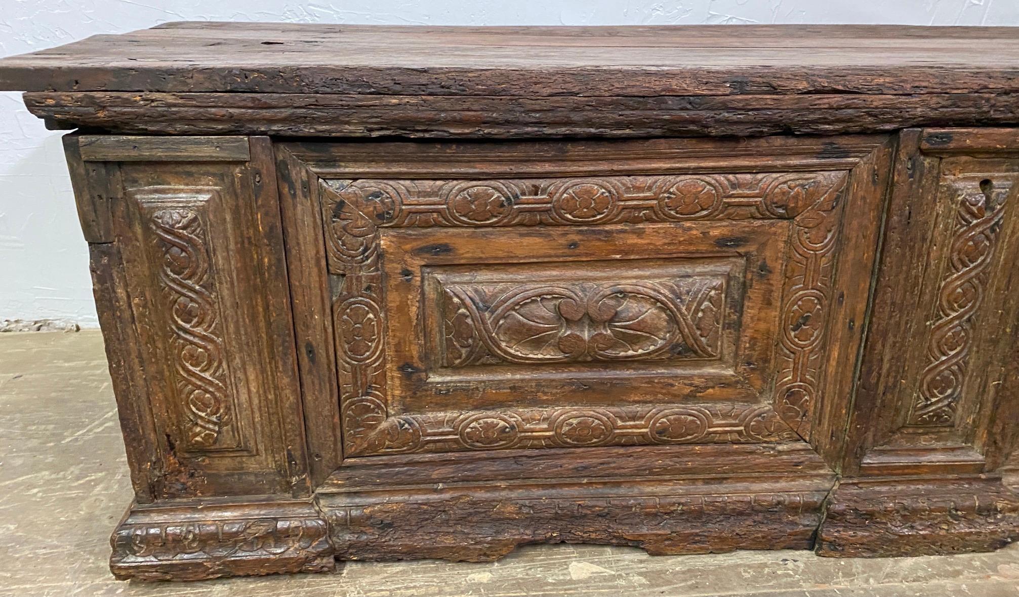 A wonderfully rustic early Italian Cassone with handsome time-softened wood and carved panels on the front and sides. Although this chest has suffered wood worm damage, losses to various areas and repairs made, it has only added to the charm,