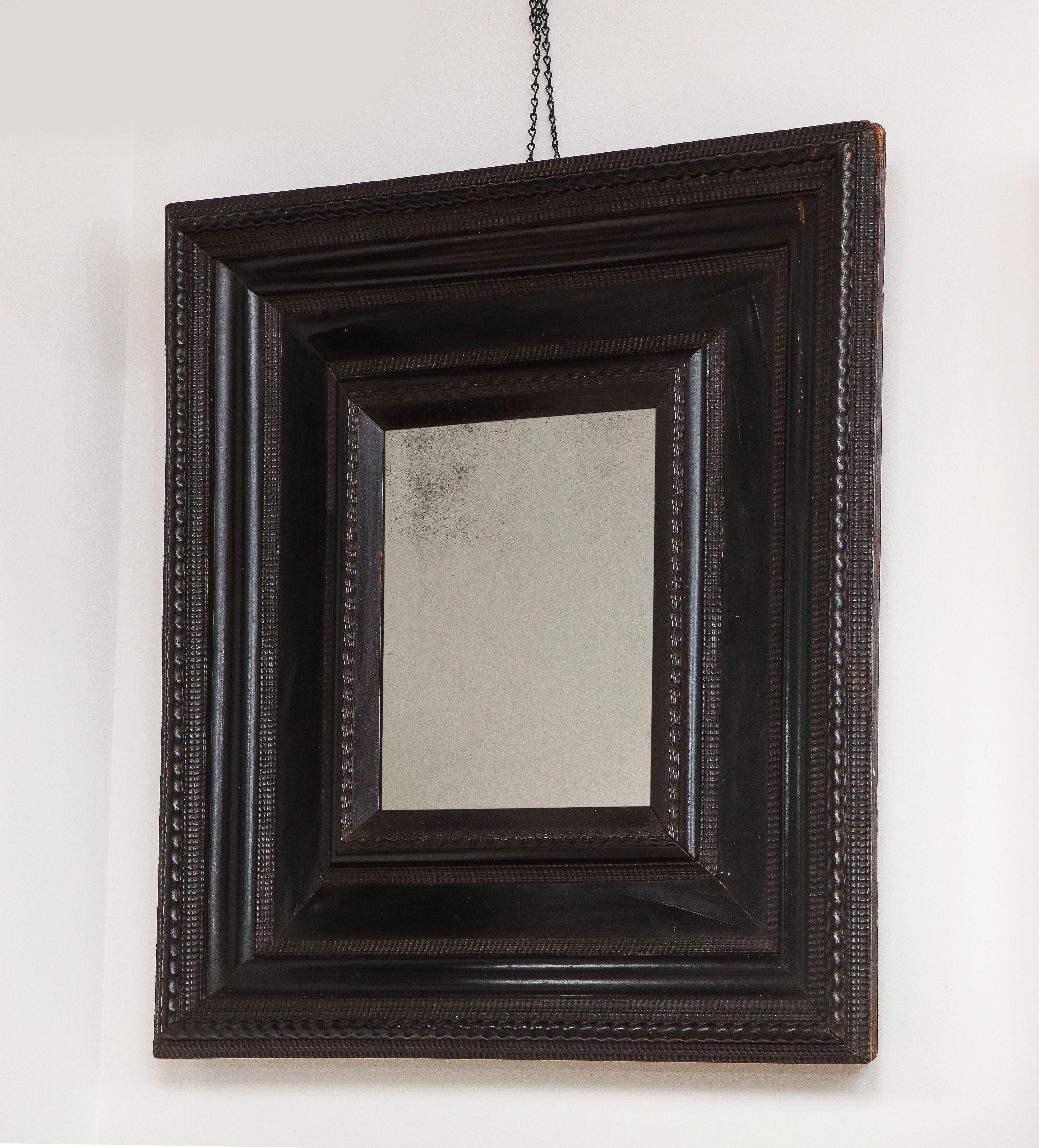 Early 18th c. Italian ebonized mirror with guilloche detail & old mercury glass.