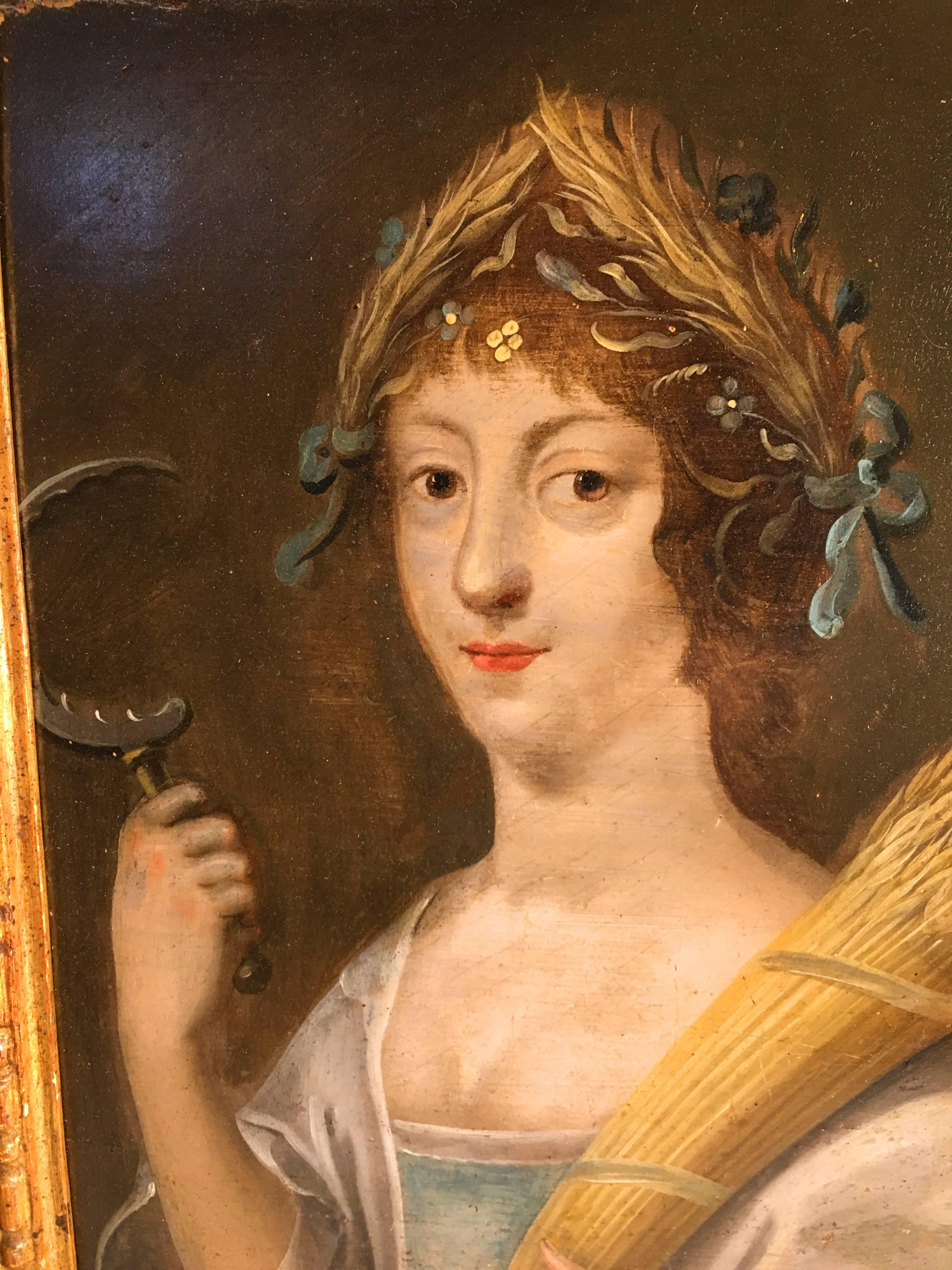 An early 18th century oil-on-board portrait of the Goddess Demeter, holding a scythe and a sheaf of wheat, with a wreath of grain as a crown on her head, in period costume. In an antique giltwood frame.
