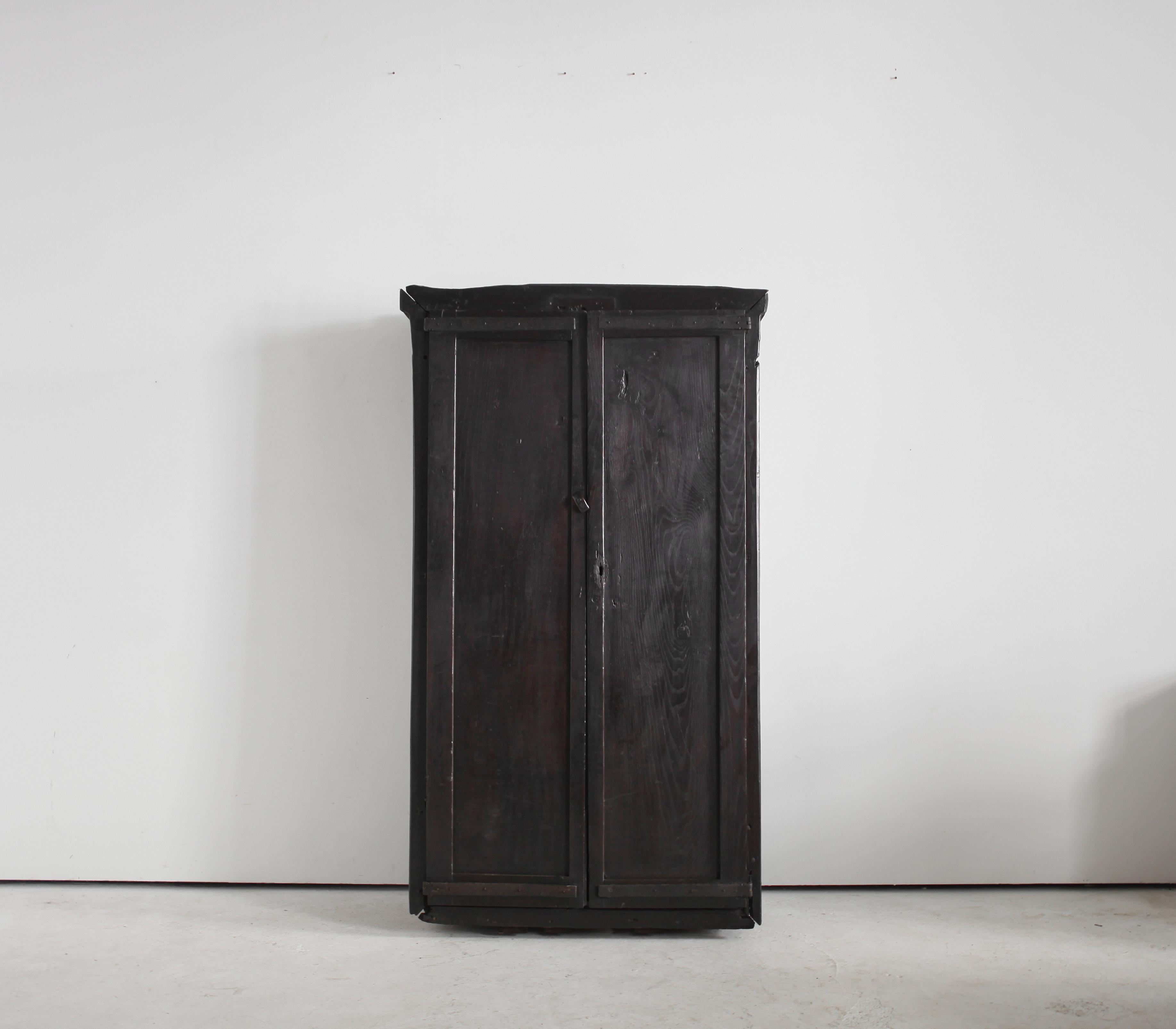 A large early 18th C. Hewn chestnut cupboard from the mountains of the Basque Country.

Primitively constructed with thick slabs of chestnut & hand forged iron hardware.

Three interior solid chestnut shelves.