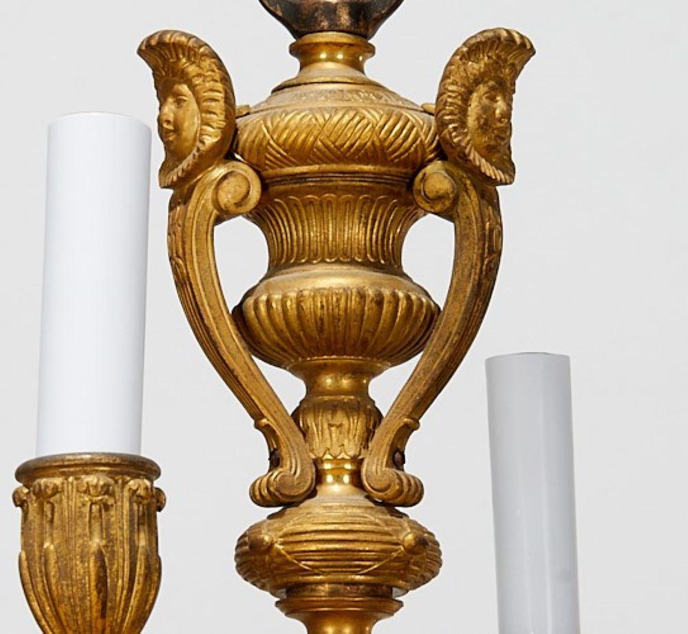Early 18th C., France, a Régence Ormolu Chandelier from The Keck Collection, sold Sotheby's 5 Dec 1991. The six light chandelier with a support composed of a gadrooned baluster-shaped urn flanked by three scrolled consoles surmounted by masks, the