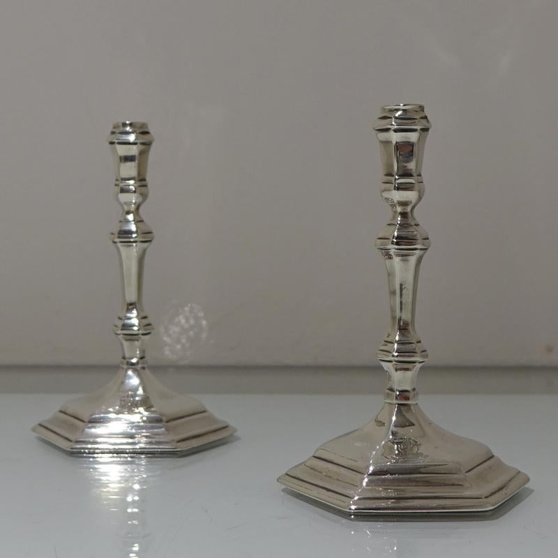 A stunning pair of plain formed early Georgian cast hexagonal silver taper-sticks. The pedestal bases both have elegant contemporary crests.

Measures:

Weight: 6.9 troy ounces/215 grams

Height: 4.7 inches/12cm

Diameter: 3 inches/7.6cm.