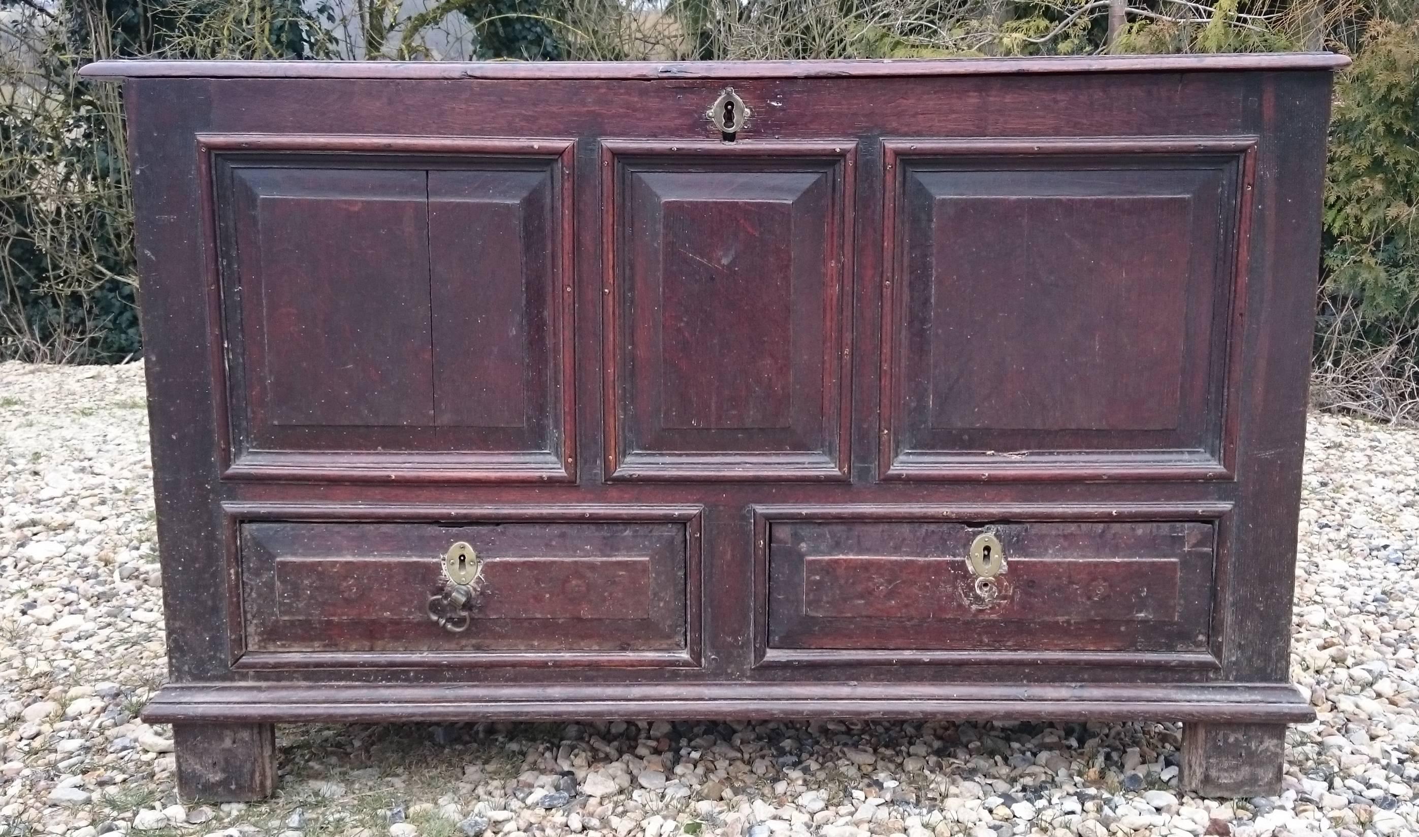 Early 18th century oak mule chest. The mule chest is a coffer at the top with drawers underneath. This mule chest has developed a lovely deep color and patina over its long life and it is good that the grain of the timber is visible. A lot of