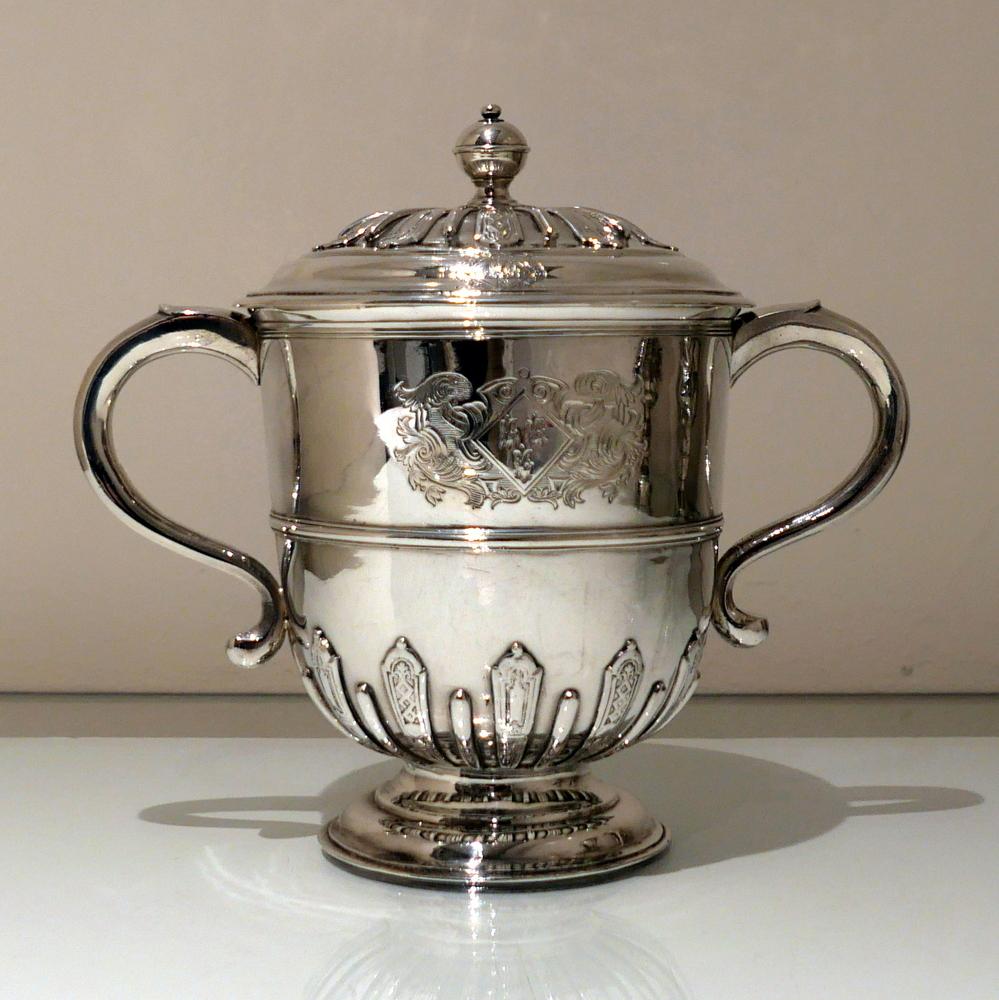 A fine and highly collectable early 18th century Britannia silver cup and cover decorated with elegant applied strap work designs. The handles are scroll formed and there are beautifully hand engraved crest/armorial for importance.

 

Weight: