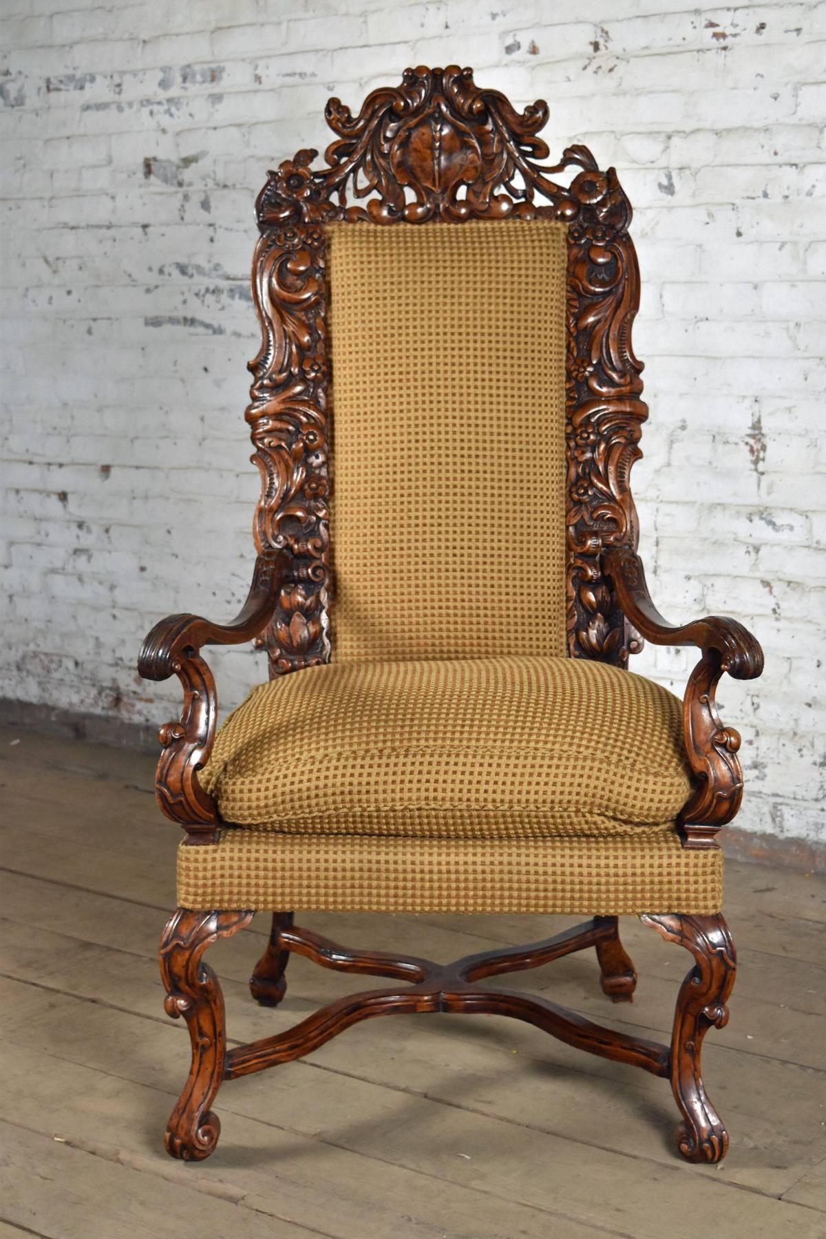 Very Comfortable and Rare Armchair of Generous Proportions and stately appearance, exuberantly carved Beech Wood frame, with scrolling floral motives, wavy open arms, cabriole legs joined by shaped X-stretchers.
Seat height 19
