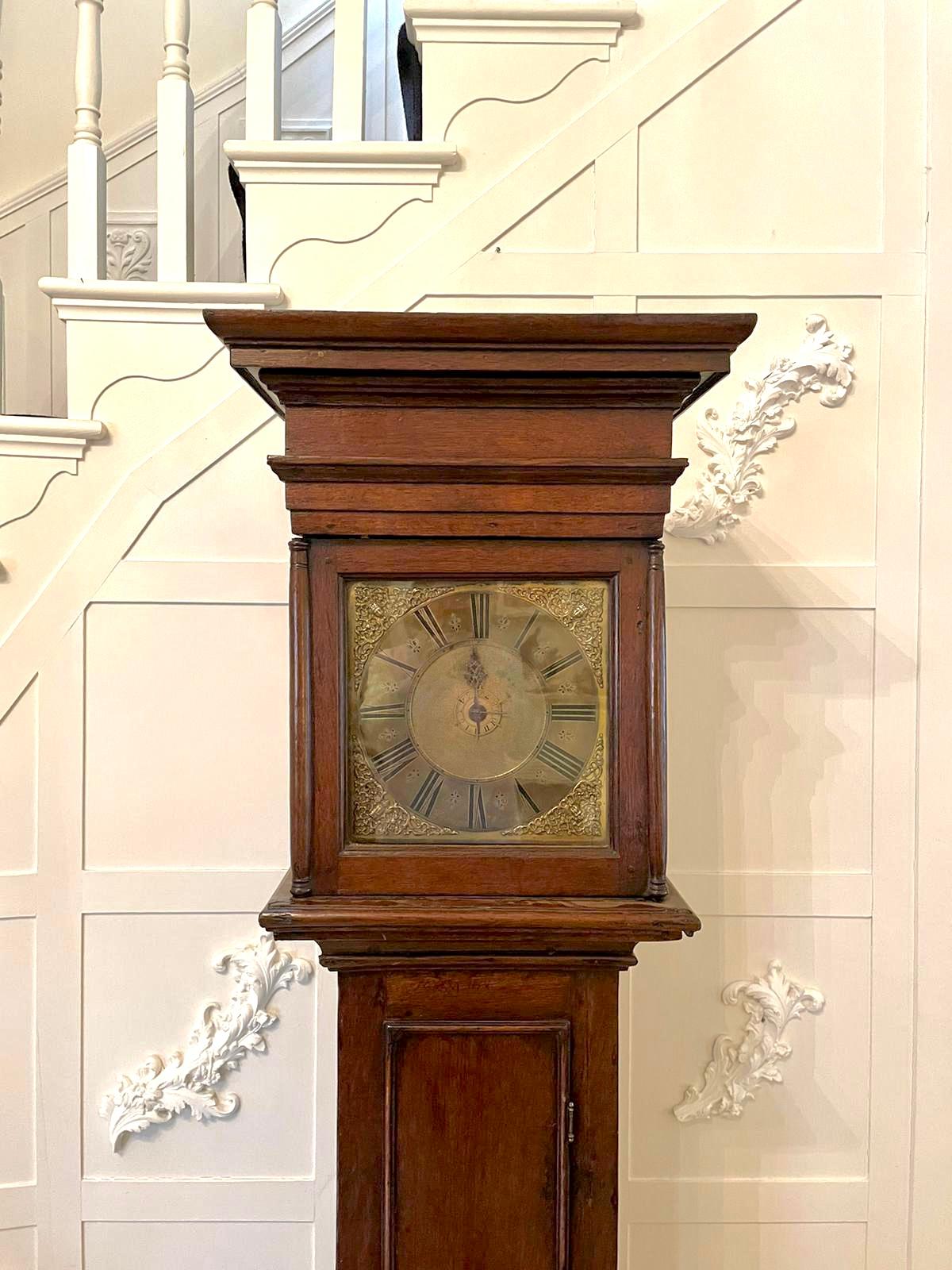 Rare Early 18th century brass face antique grandfather clock by Newman of Norwich having a stunning square brass face one hand and a thirty hour birdcage movement striking each hour on the original bell and featuring a rare alarm. It has the