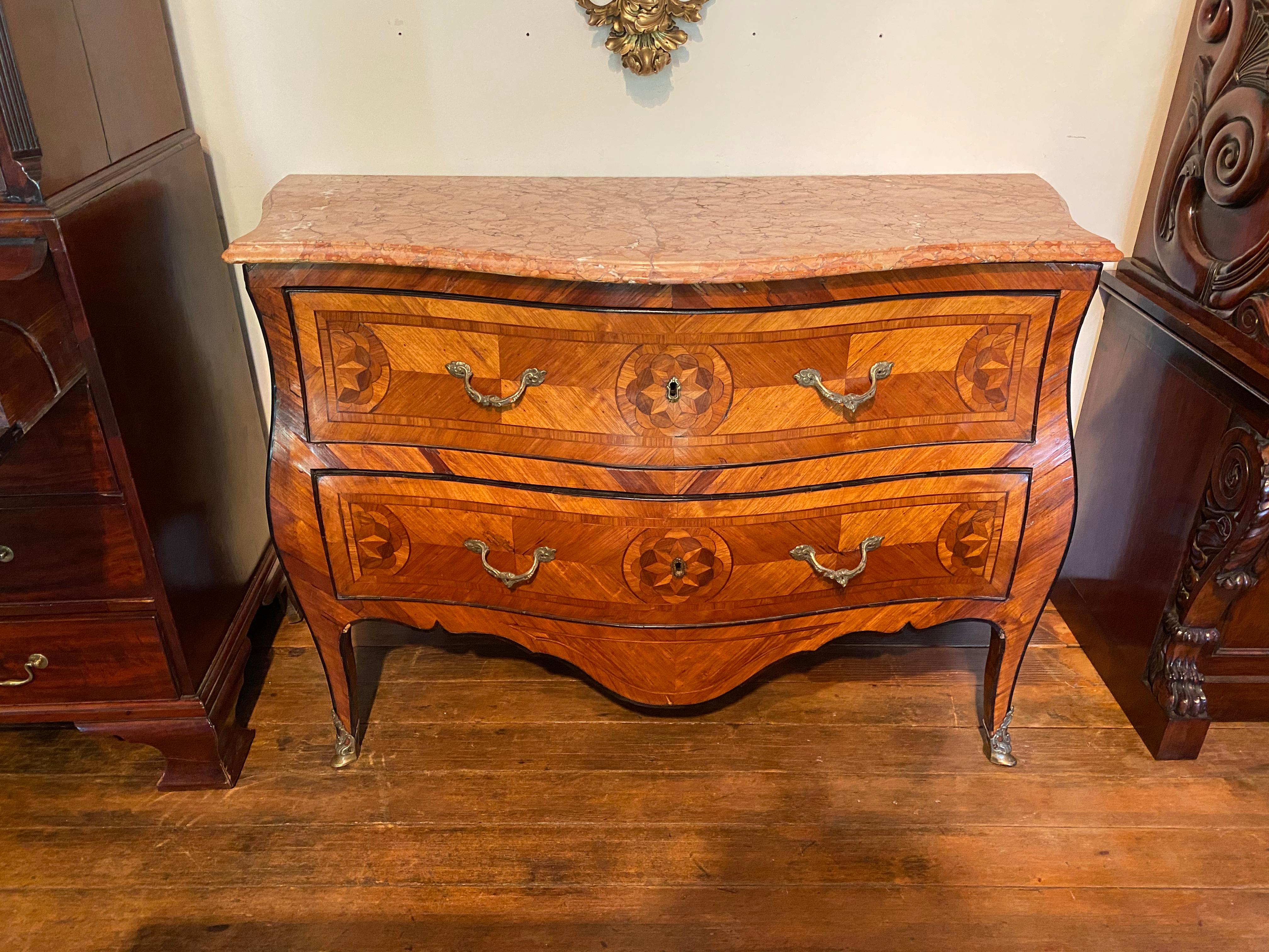 Early 18th century bronze mounted inlaid Italian marble top commode. Geometric stars and flowers inlaid in center and sides, ebony inlaid banding, original bronze mounts.