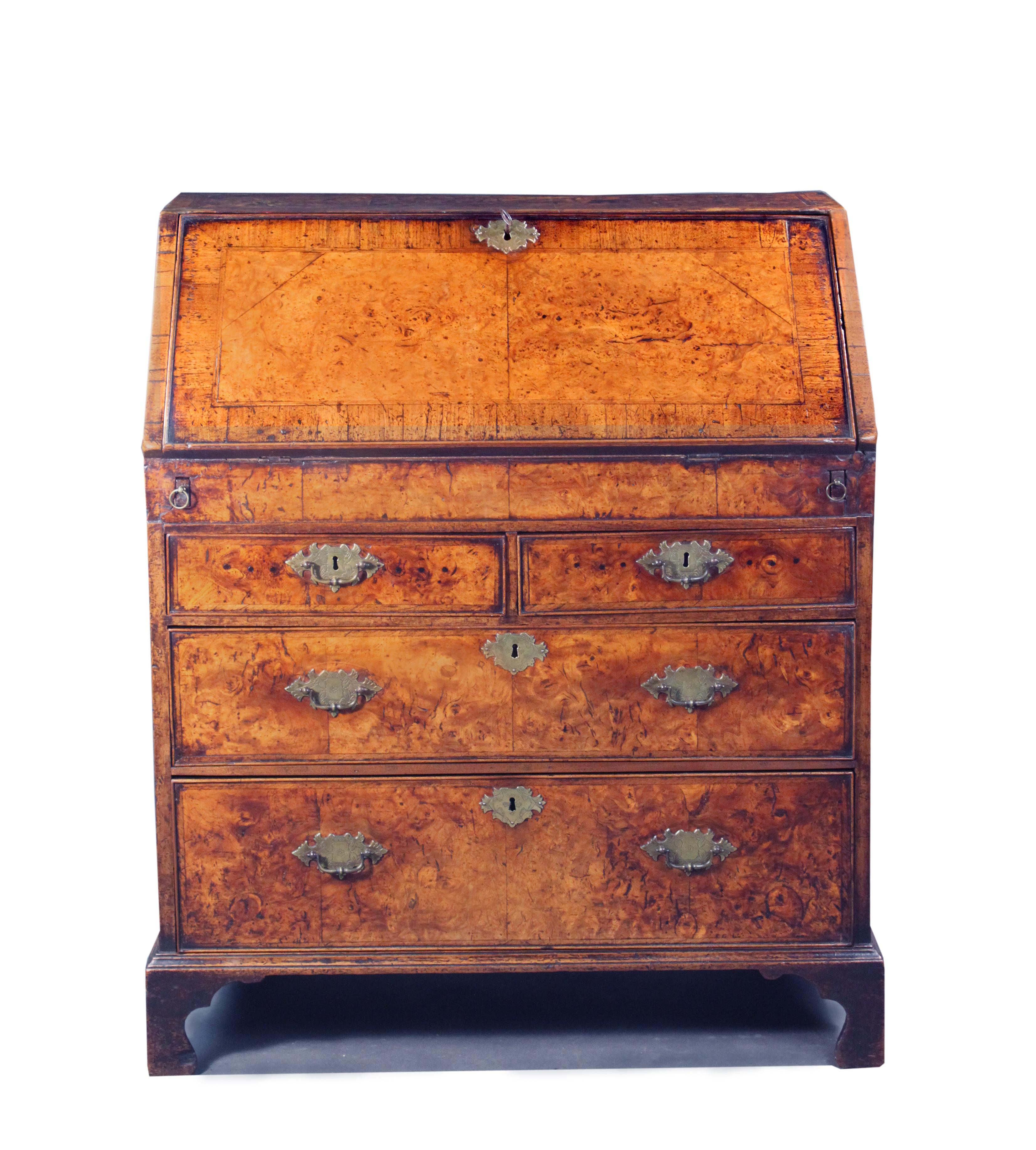 An early 18th century burr ash veneered bureau with a well and stepped interior. The drawers, fall and top have cross-grained and herring bone banding and matched veneers.
The colour and patina is exceptional. The bureau is made in exactly the same