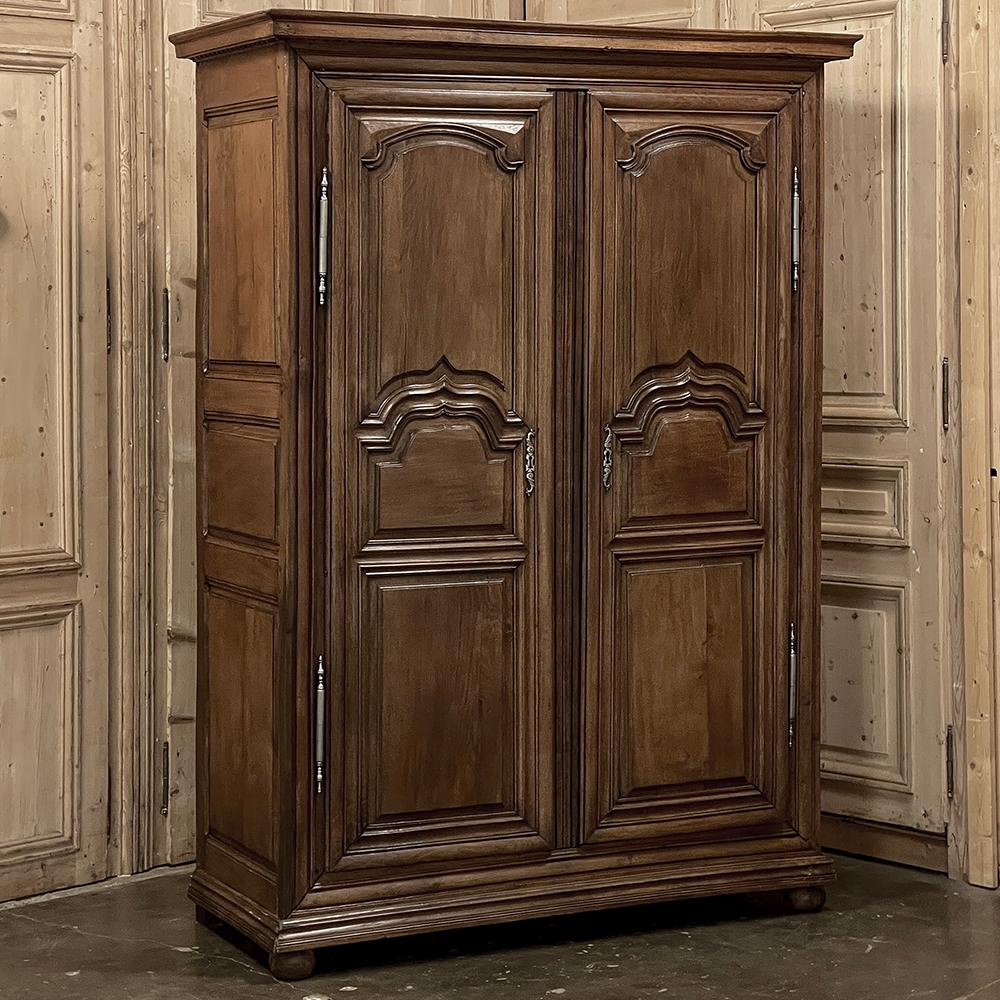 Early 18th Century Country French Louis XIII Armoire is a stately expression of the genre, rendered by talented artisans with what would today be considered primitive tools yet resulting in a lasting testament to techniques and training honed over