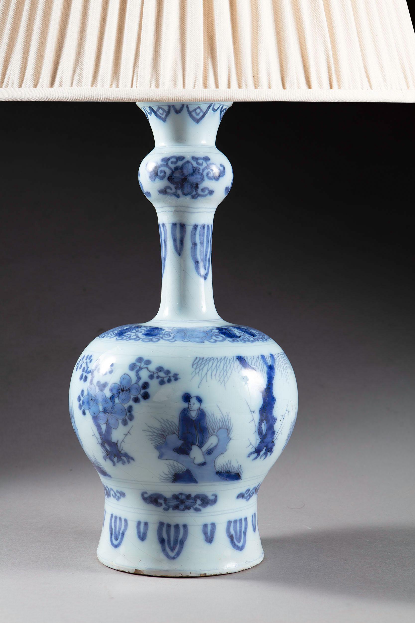 A charming early 18th century Dutch Delft blue and white knobble vase decorated with repeating seated Chinese figures interspersed with trees possibly representing the four seasons Willow, Peach, and two ornamental Prunice trees. 
The Netherlands,