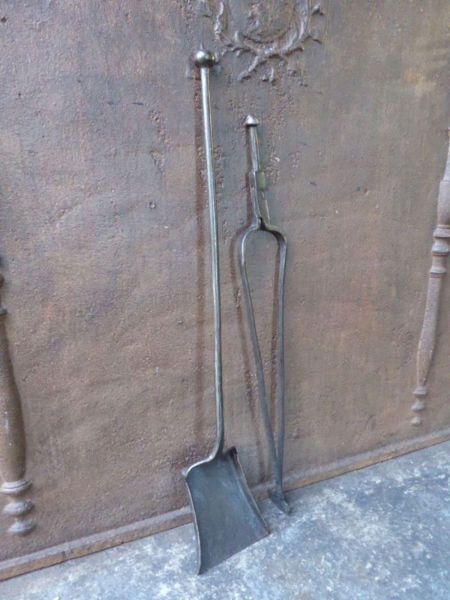 Set of early 18th century Dutch fireplace tools. The tools and hanger are made of polished wrought iron. They are in a good condition and fully functional. 
