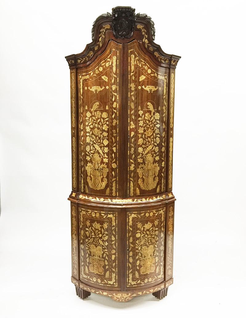 Early 18th century Dutch marquetry large corner cupboard

A large bow front corner cabinet with fabulous marquetry in various fruit woods
The cupboard made of oak with veneer in fruitwood marquetry
Fabulous marquetry with enormously beautiful scene