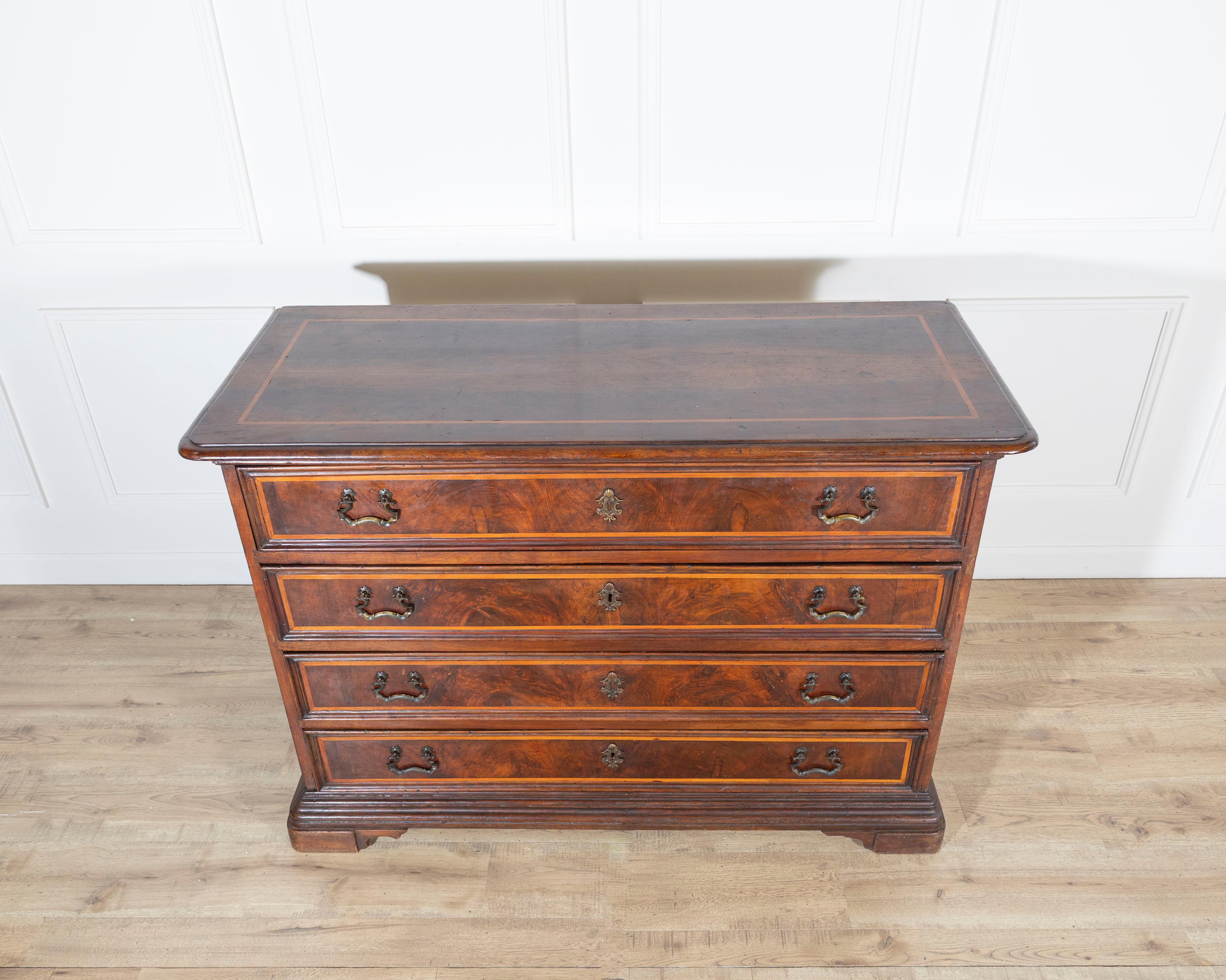 
An exceptional early 18th-century chest of drawers from the Emilia region of Italy, crafted in solid walnut and delicately veneered with fine fruitwood fillets. This elegant piece showcases the perfect harmony between structure and decoration, with