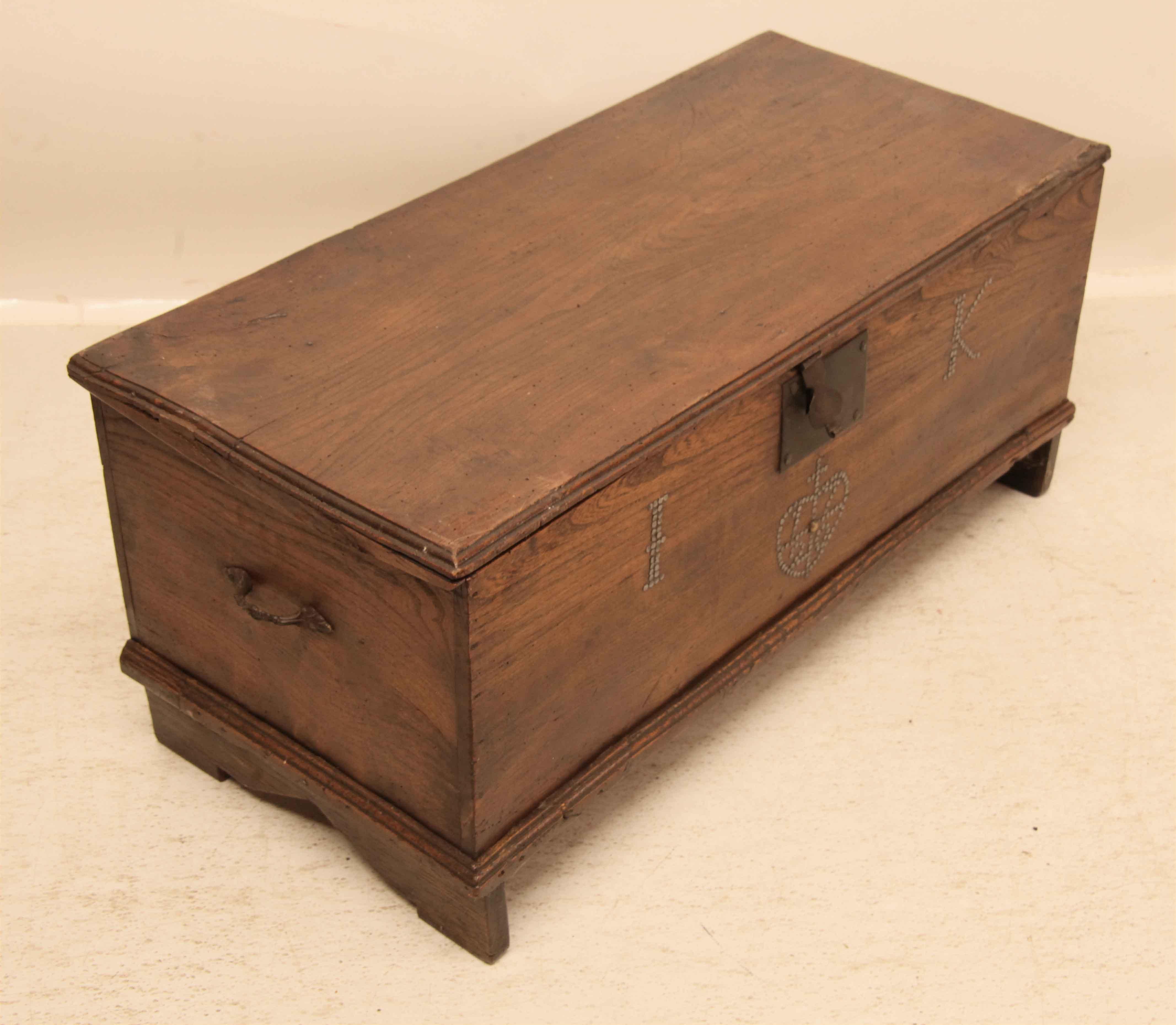 Early 18th century English elm coffer with beautiful original color and patina,  the diminutive size gives one lots of options for uses in the home.  The front has two features done with miniature round head metal nails- the large initials 