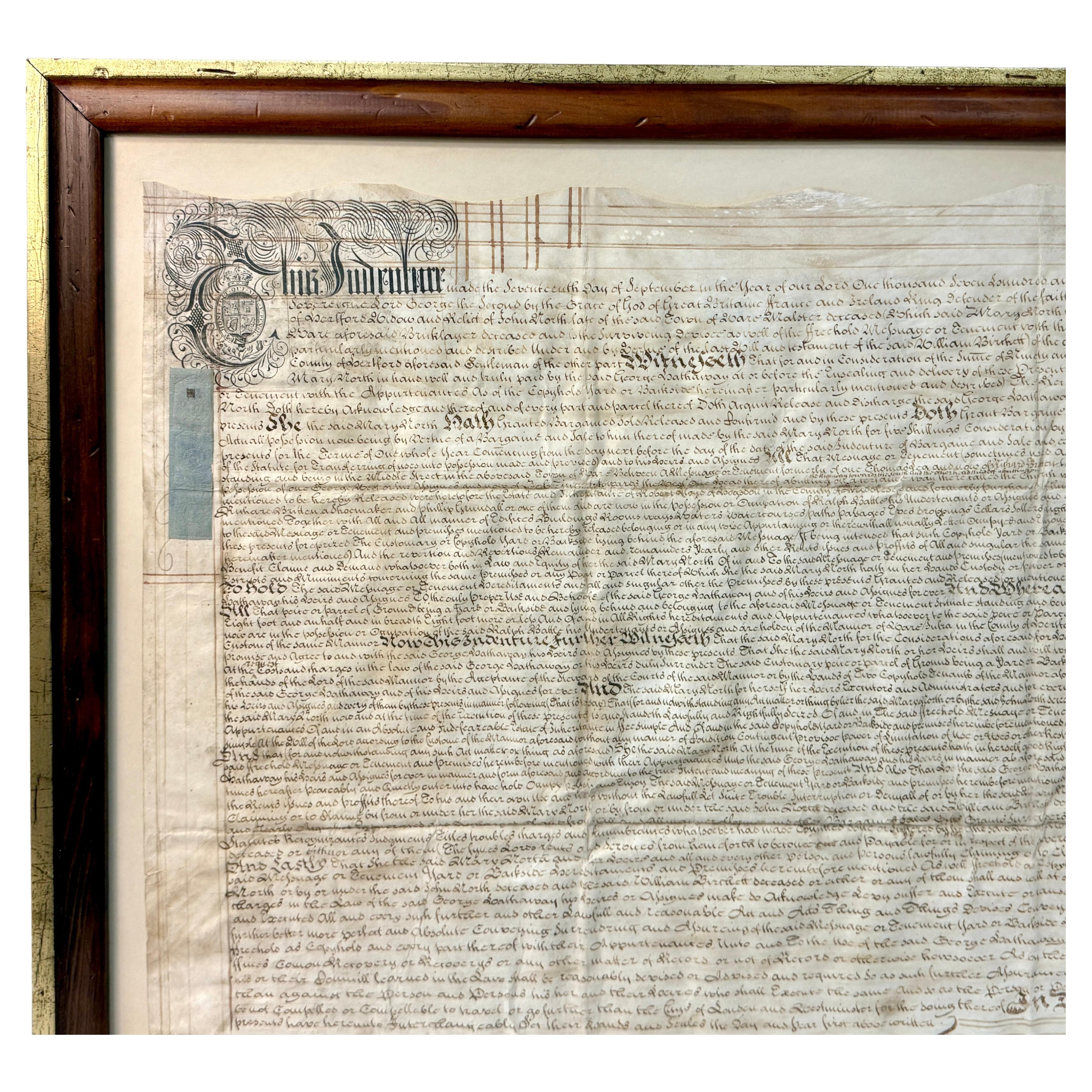 Un grand document d'engagement encadré du début du XVIIIe siècle. Le document (acte) est rédigé avec de nombreux détails écrits à la main. Délivrés en trois parties, les indentures étaient des documents juridiques coupés avec des bords ondulés, ce