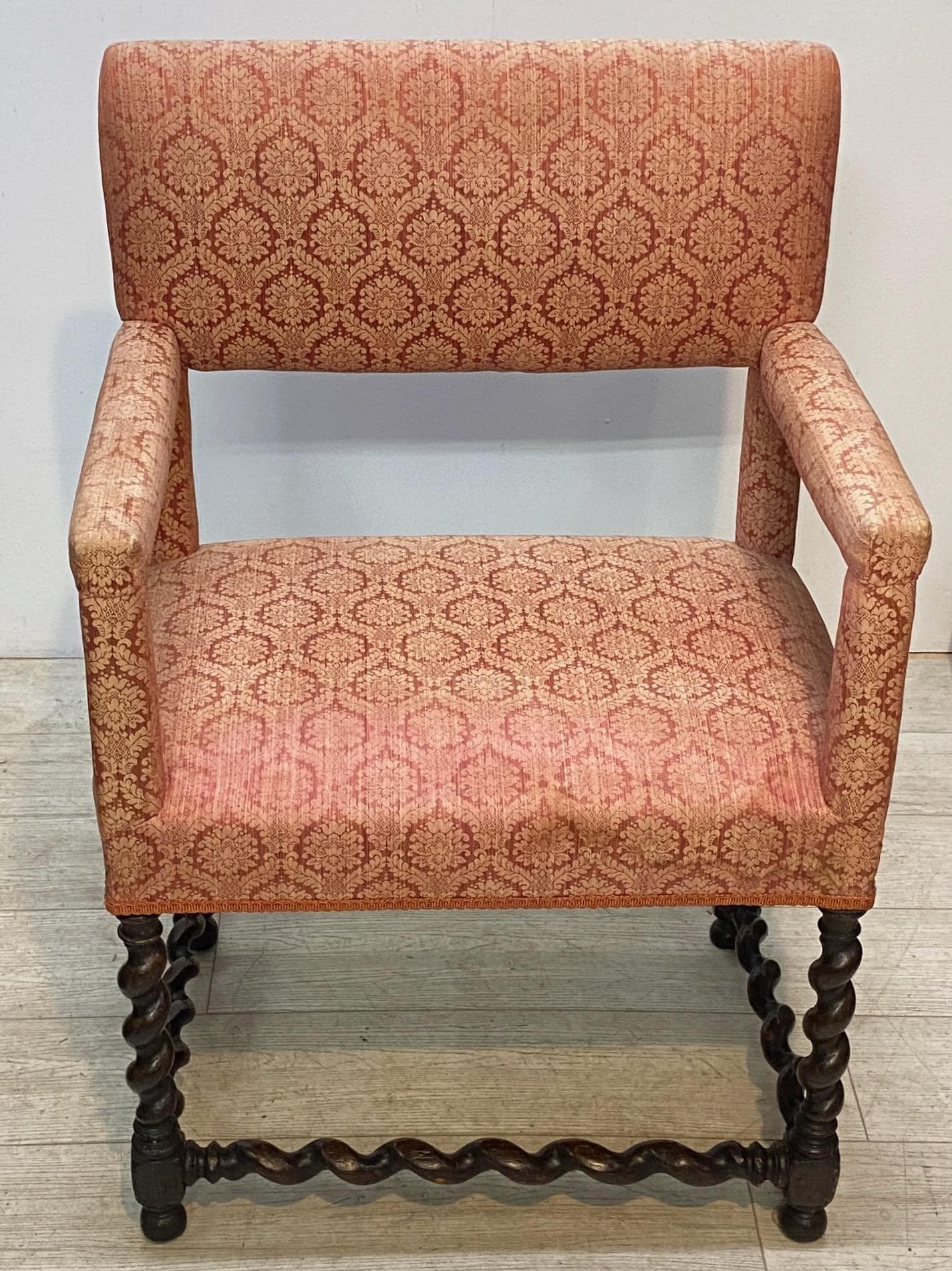 An exceptional example of a period 18th century oak armchair with barley twist legs and stretchers. In unusually good condition. Upholstered in the mid 20th century. Sturdy and strong, but ready for new upholstery. 
England, early 18th century