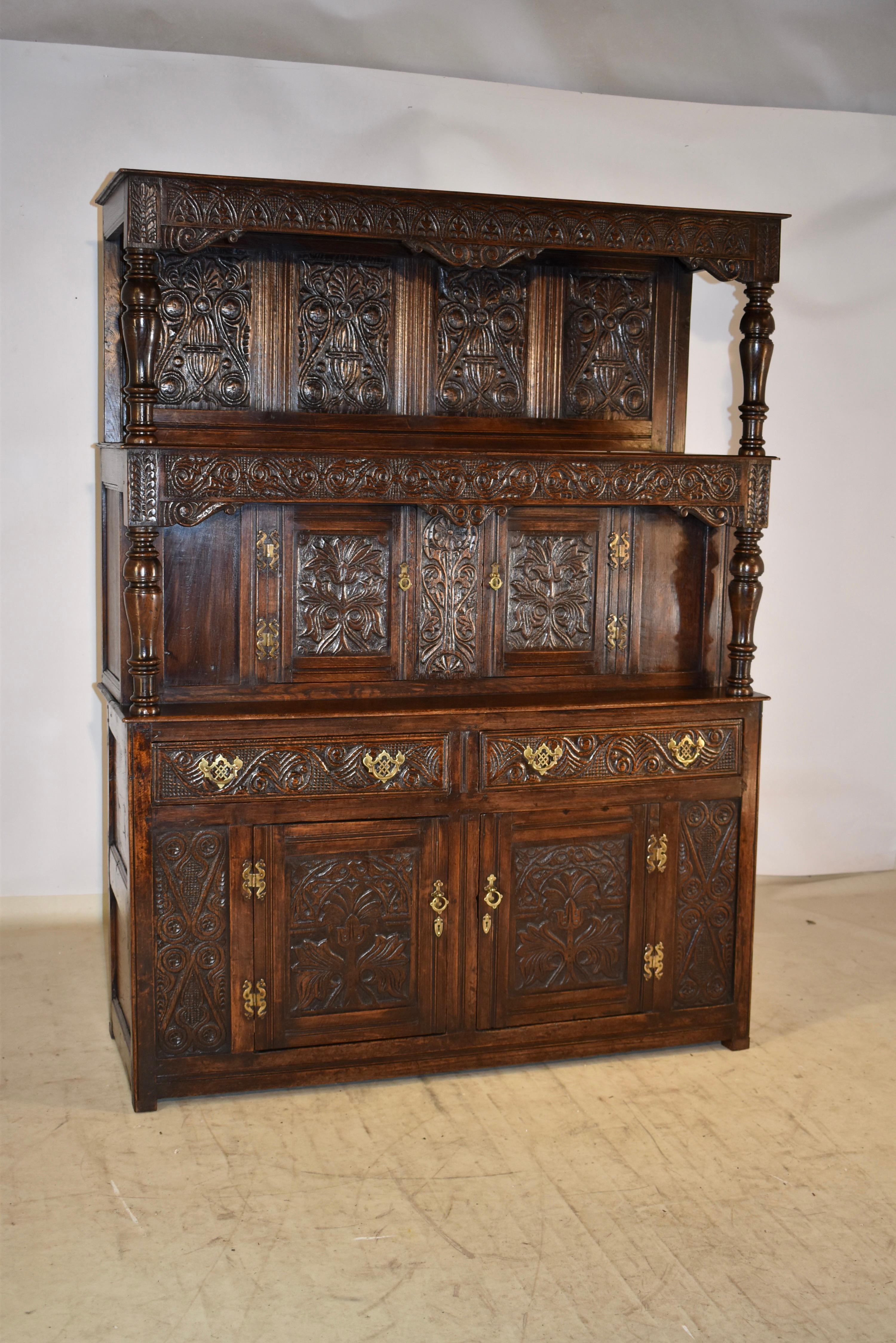 Very unusual early 18th century tridarn press cupboard from England.  This piece is truly wonderful.  It is unusual in that it has two shelves instead of just one, so it has triple tiers, which is much more stately and gives it some additional