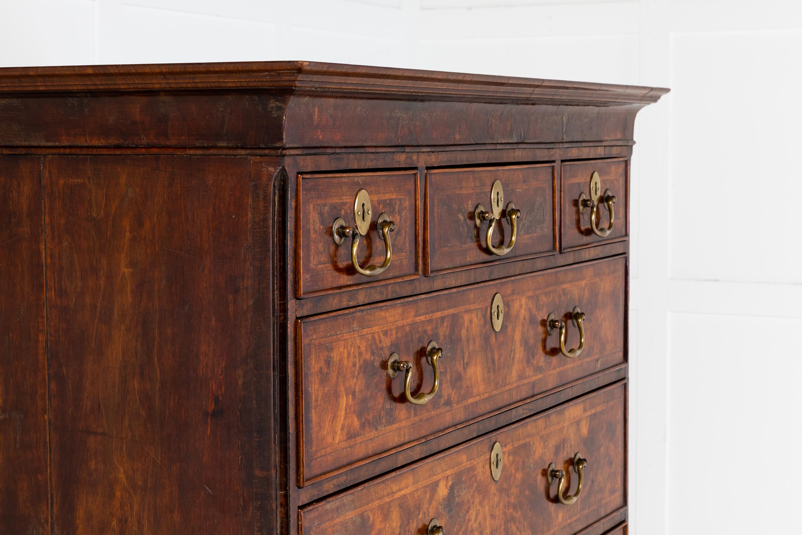 Early 18th Century English walnut chest on chest having brushing slide, with excellent choice of quality walnut veneer. Having delicate narrow moulded detail to the corners of the upper section.

The upper chest, consisting of three short drawers