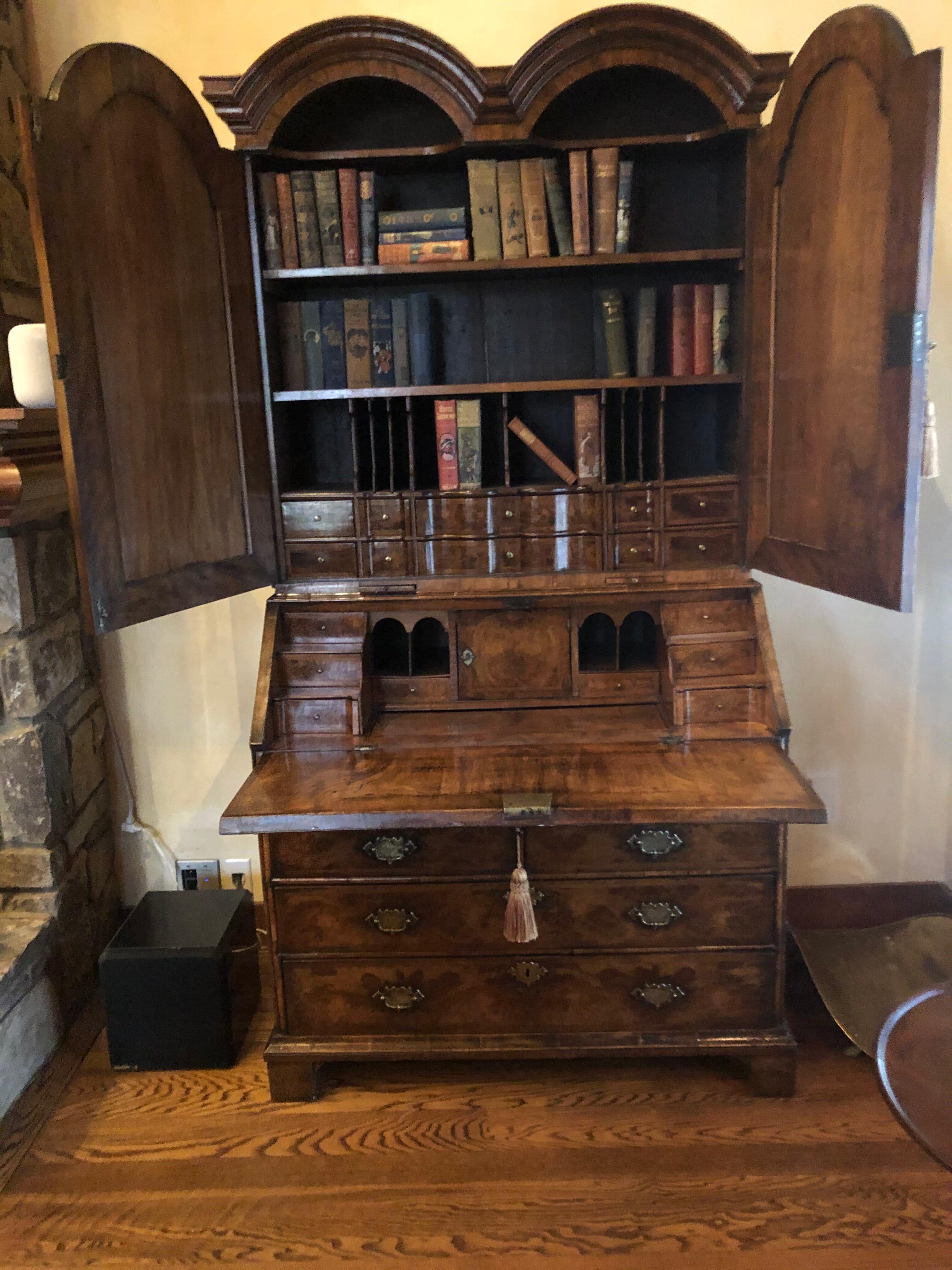 This 18th century William and Mary Bureau bookcase is outstanding. With its rich color and original condition, it is a fine example of the intricate craftsmanship that top quality cabinet makers provided during this period.
Beneath a “double dome”
