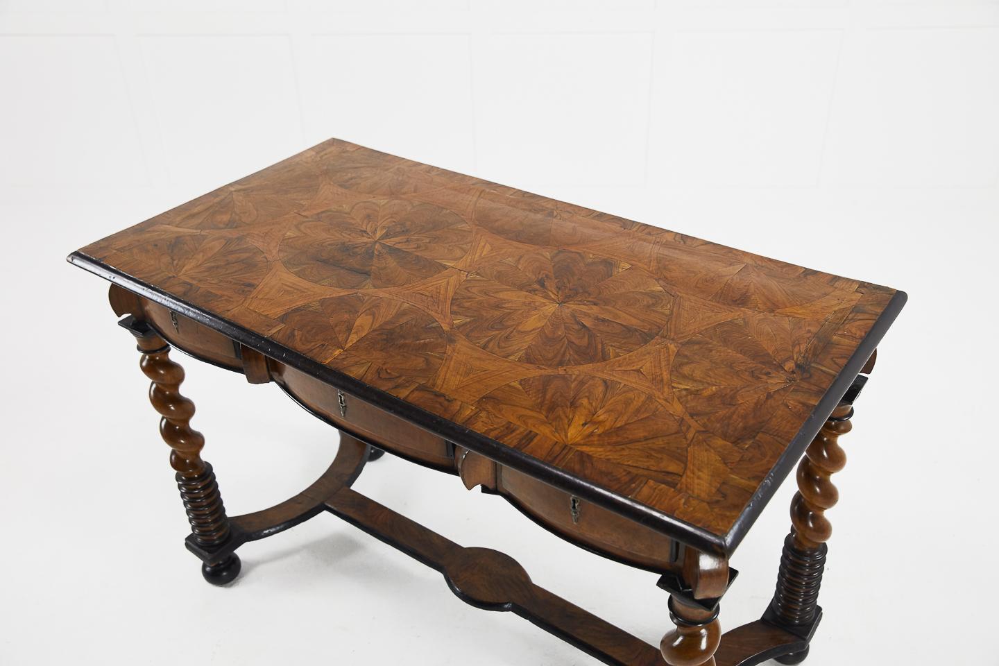 Early 18th Century French three-drawer walnut table with beautifully inlaid geometric patterned top.