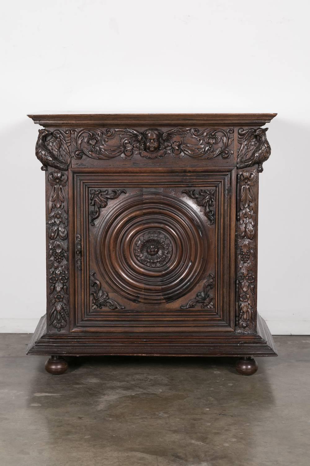 A very impressive Louis XIII style confiturier or jam cabinet handcrafted of solid walnut by talented artisans near the Bordeaux region during the early 1700s. Obviously made to specific order, this richly carved cabinet has a rectangular top and