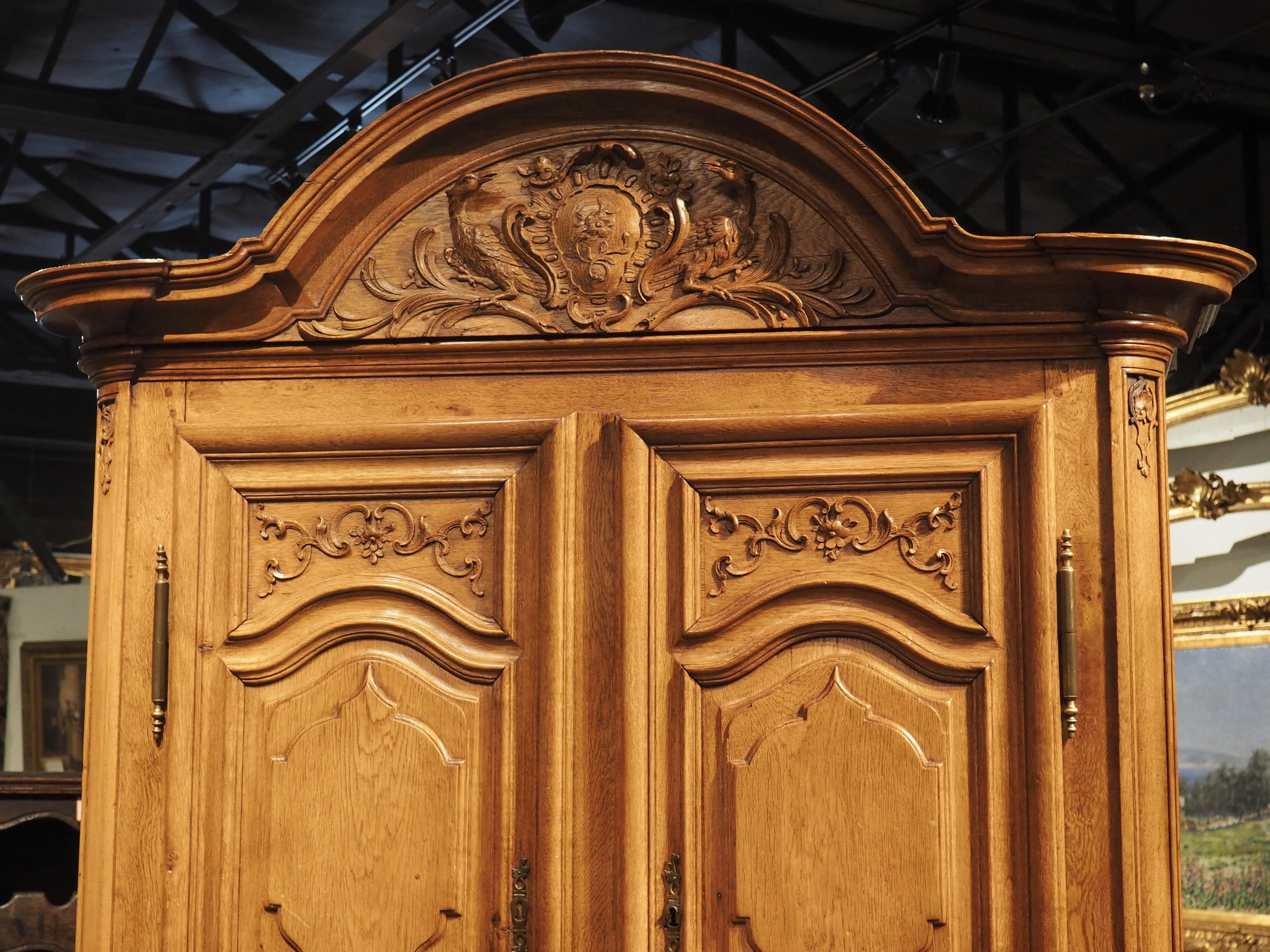 Colmar, where this handsome buffet deux corps was crafted, is an affluent commune in the Alsace region of France, a mere 15 miles from the German border. Because of this proximity, the hand-carved oak cabinet features some elements that were