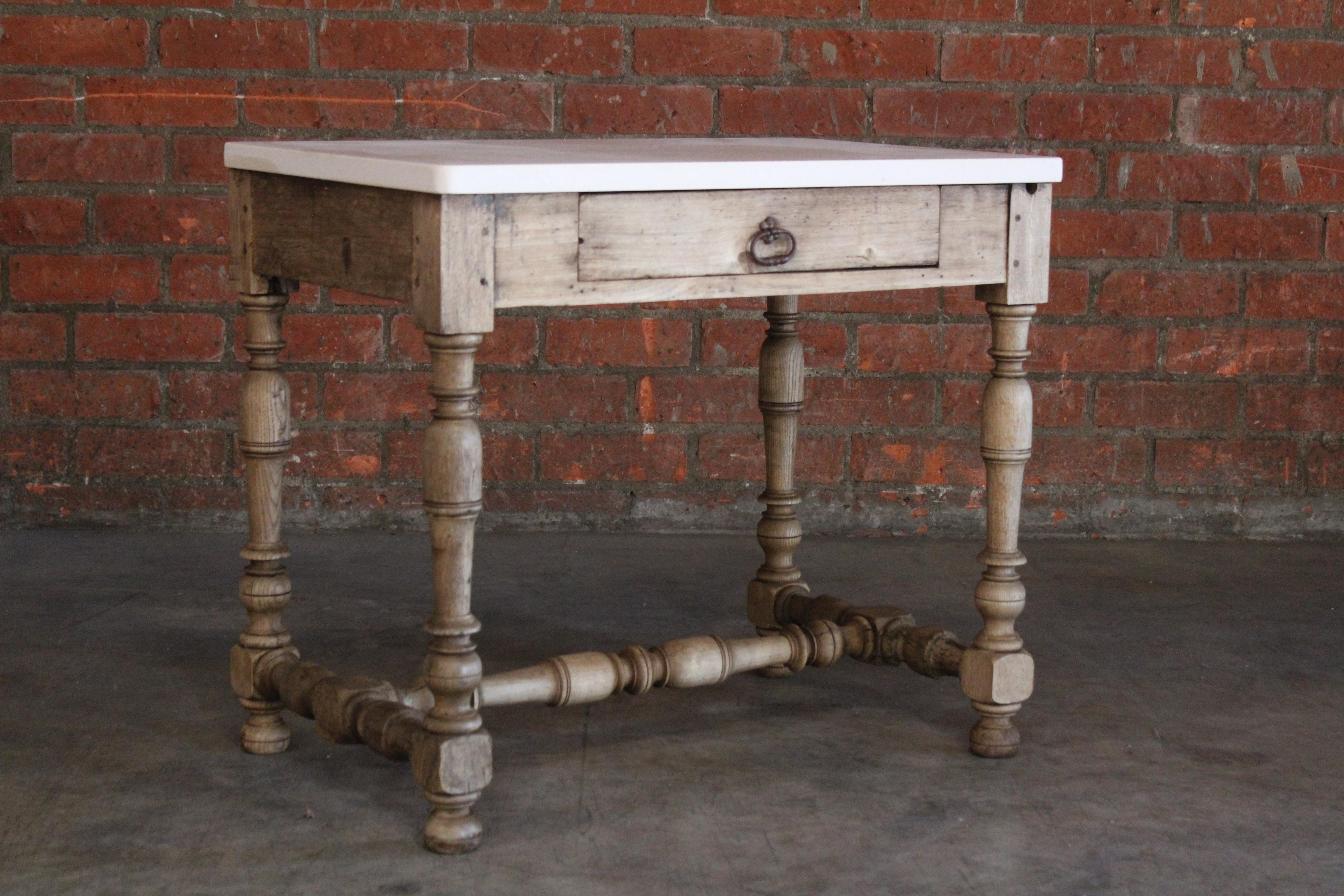 An antique 18th century console table with drawer in oak. New French limestone top. In good condition with a beautiful patina to the oak frame. The table has been lightly waxed and joints reinforced. Original iron drawer pull shows patina.