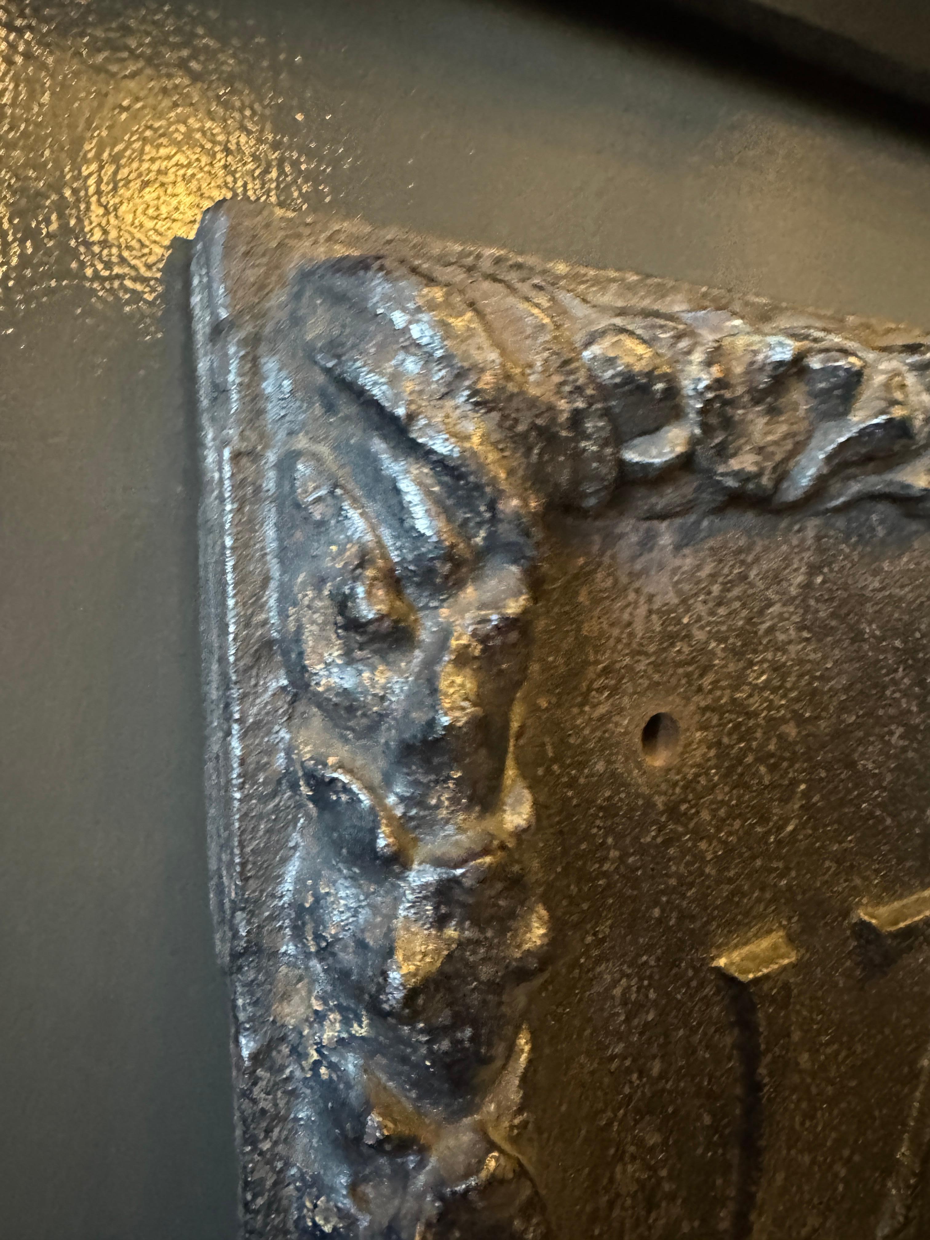 Early 18th Century French Provincial Cast Iron Fireback

Firebacks were placed at the rear of a fireplace to protect the wall from heat and radiate warmth into the room. This pieces appears to depict a fox carrying religious symbols, possibly