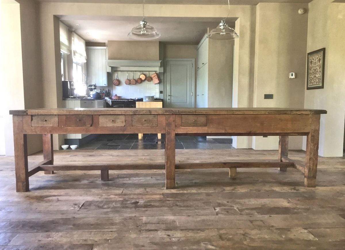 A large oak refectory table. The thick 3 plank top on a simple base with no less then 11 drawers, some of then cut out to fit wooden dishes. The whole piece has a beautiful patina and attractive proportions.
Tables like these most likely stood in