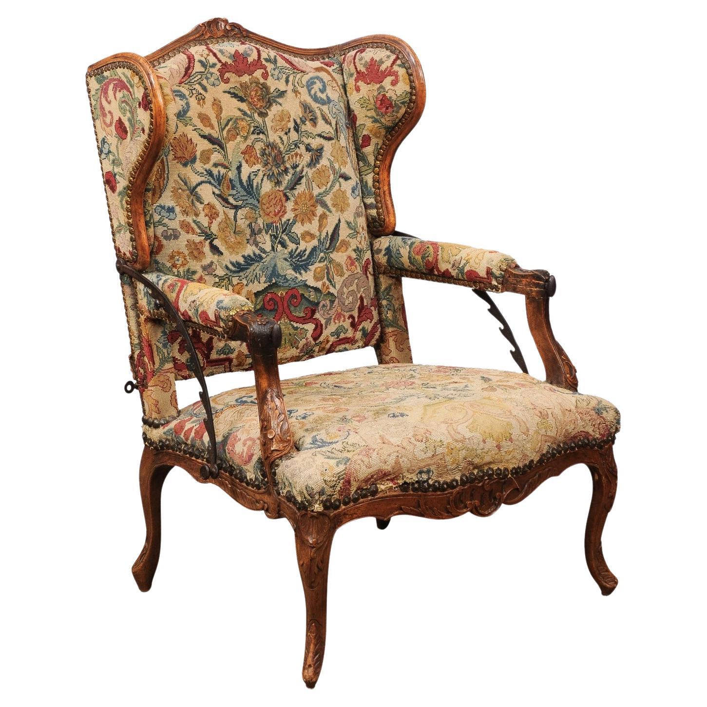 Early 18th Century French Regence Period Walnut Ratchet Wing Chair with Needlewo For Sale