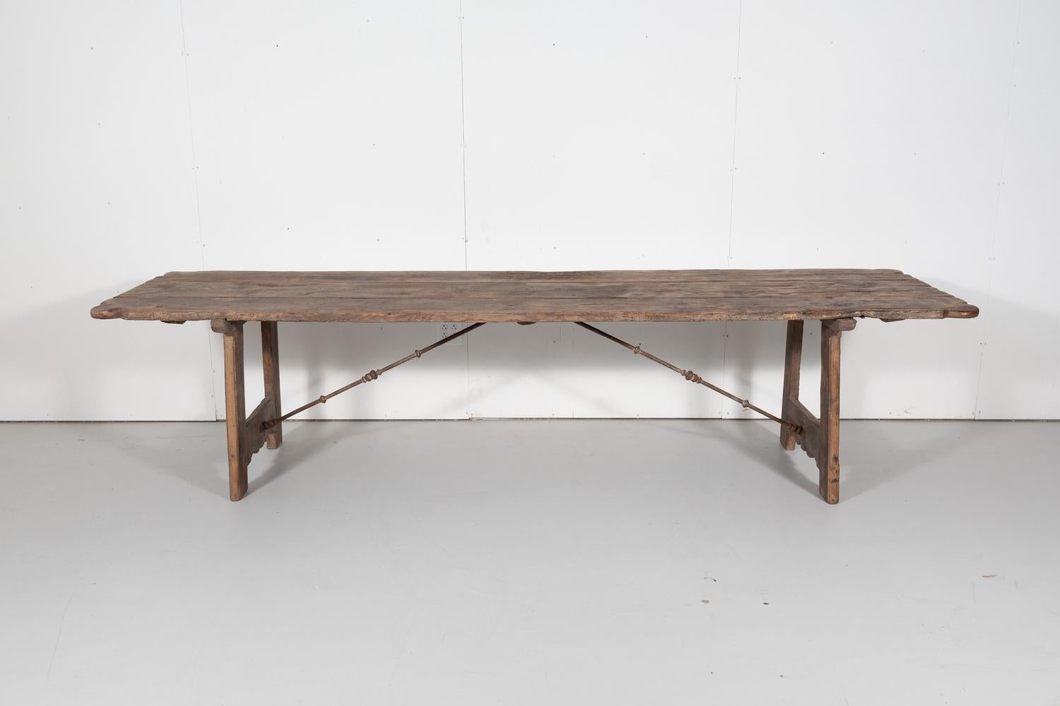 Early 18th century French trestle table handcrafted of mélèze wood by talented artisans near Strasbourg for a hunting lodge in the Alsace region of France, circa 1720s. This wonderfully rustic table with its centuries old patina has a plank top with