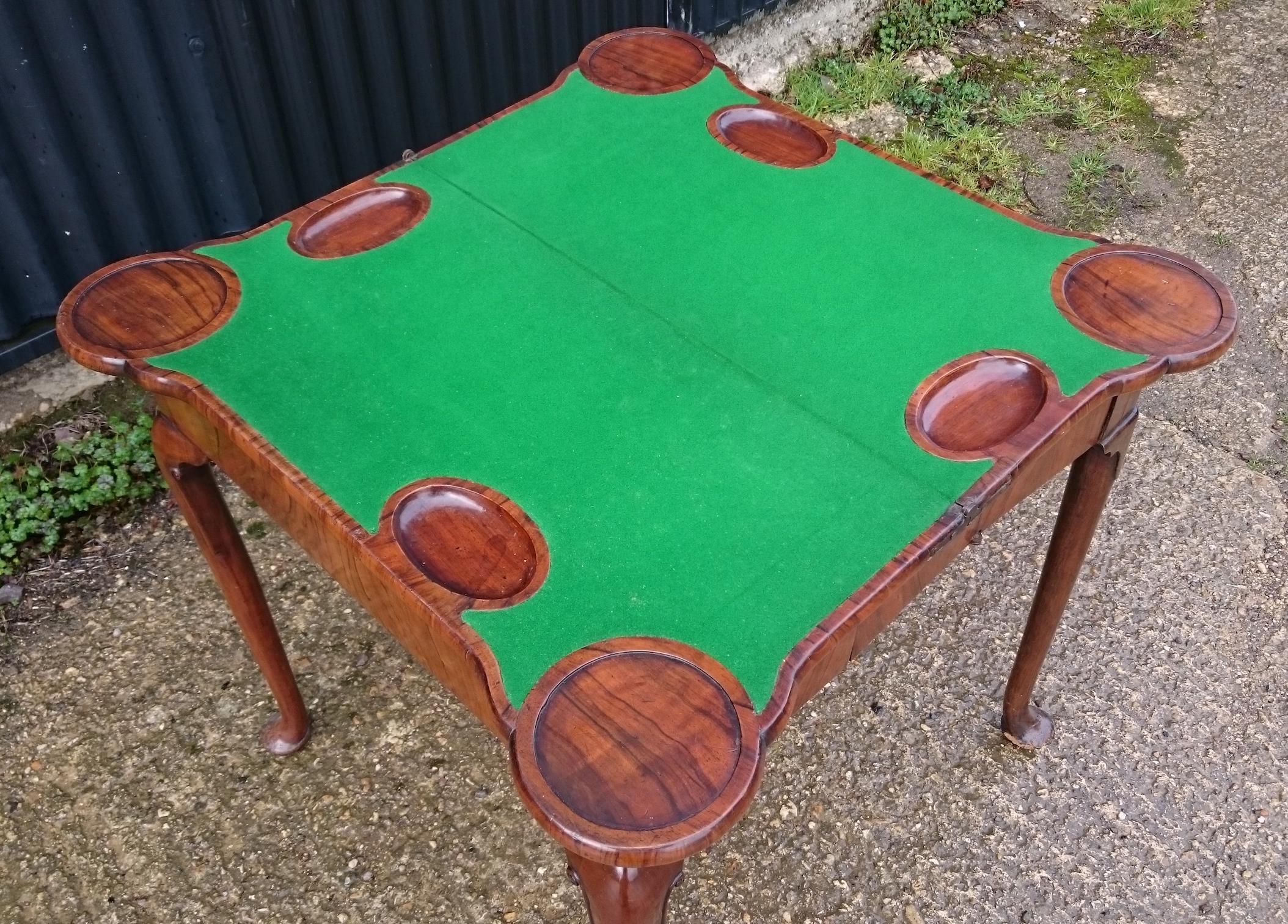Early 18th century George I period walnut antique games table standing on cabriole legs with pad feet. This table is photographed here as it came in to us and will look even better when it has been waxed. The mechanism is unusual and works very