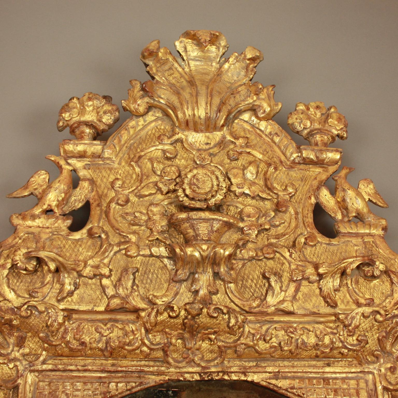 Carved French Early 18th Century Régence Vase and Birds Cresting Giltwood Mirror For Sale