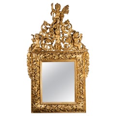 Specchio in legno dorato intagliato del primo Settecento italiano raffigurante Four Seasons