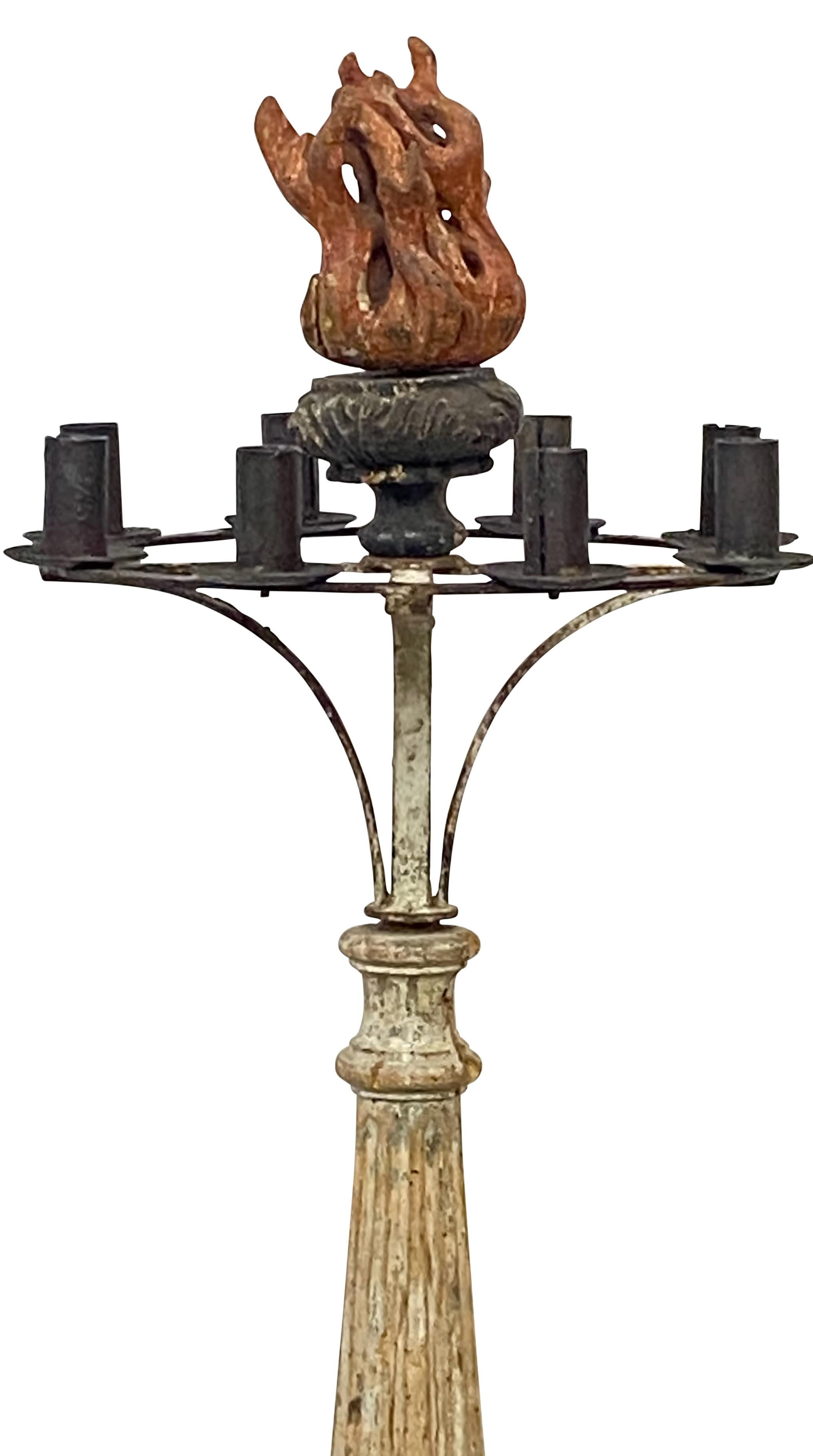An interesting and unusual cast iron and carved pine 8 light candle stand with a large wonderfully carved wood flame finial.
Remnants of old paint on the cast iron base, the support was most likely gilded at one time but now worn away.
This stand