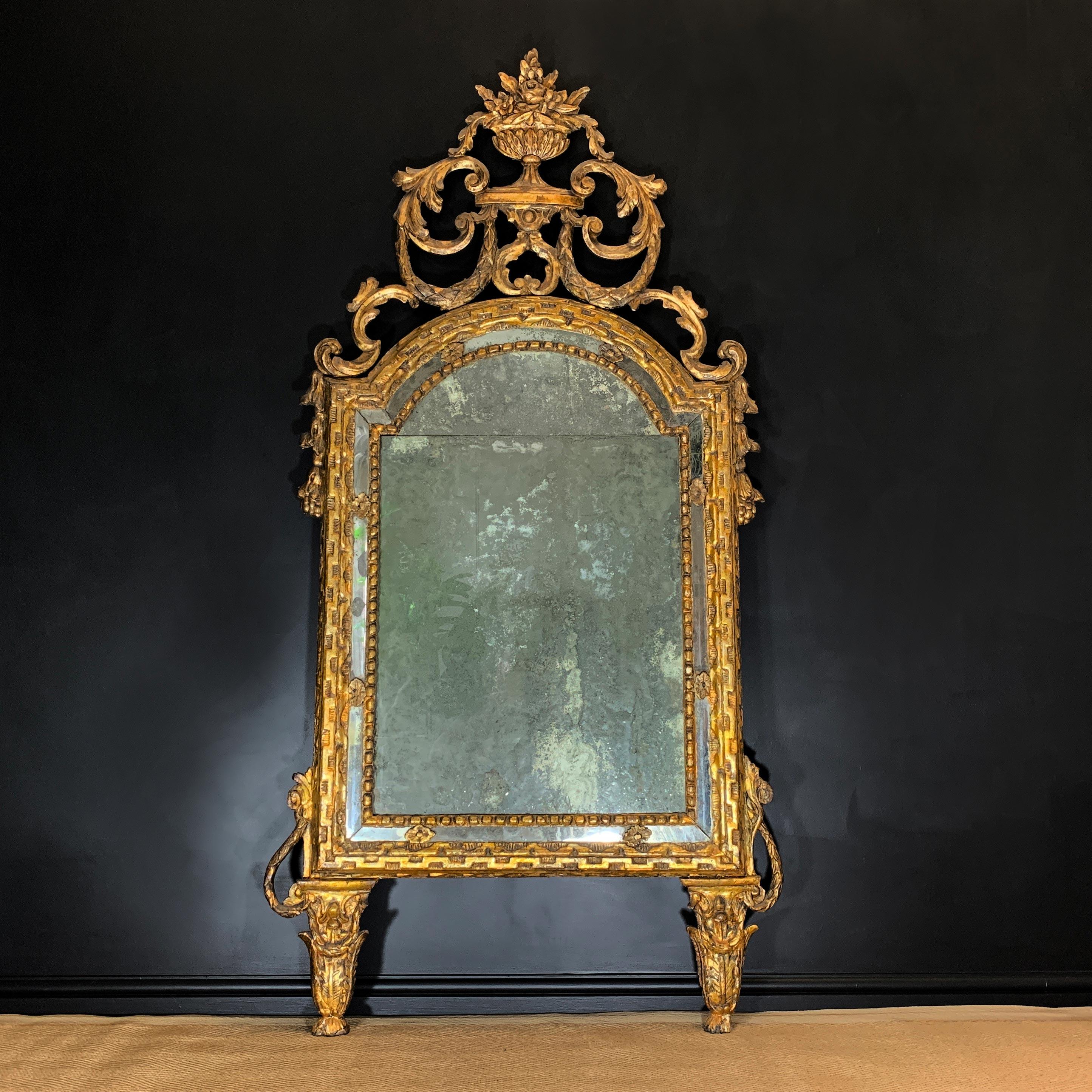 An exceptional split plate Italian mirror

Dating to circa 1730, Genoa, Italy.

This astonishing mirror is of exceptional proportions, the split mercury plate foxed and worn to perfection over the centuries, adorned with the most beautiful gilt