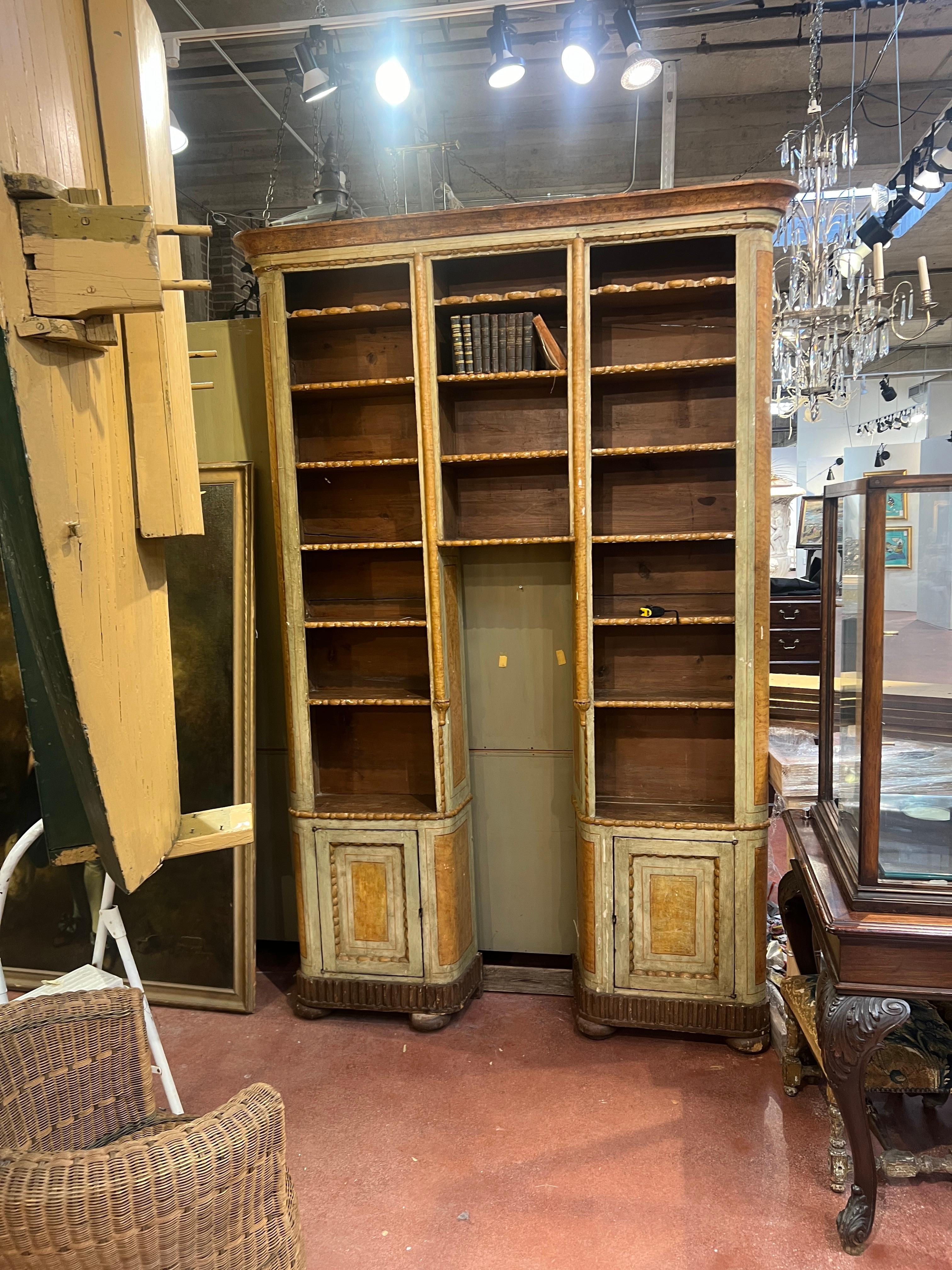 Fabulous and rare from early 18th century paint decorated continental  bookcase. One piece built to encompass a pedestal and bust or a statue. This piece features original paint, fixed shelves and cabinet doors.
