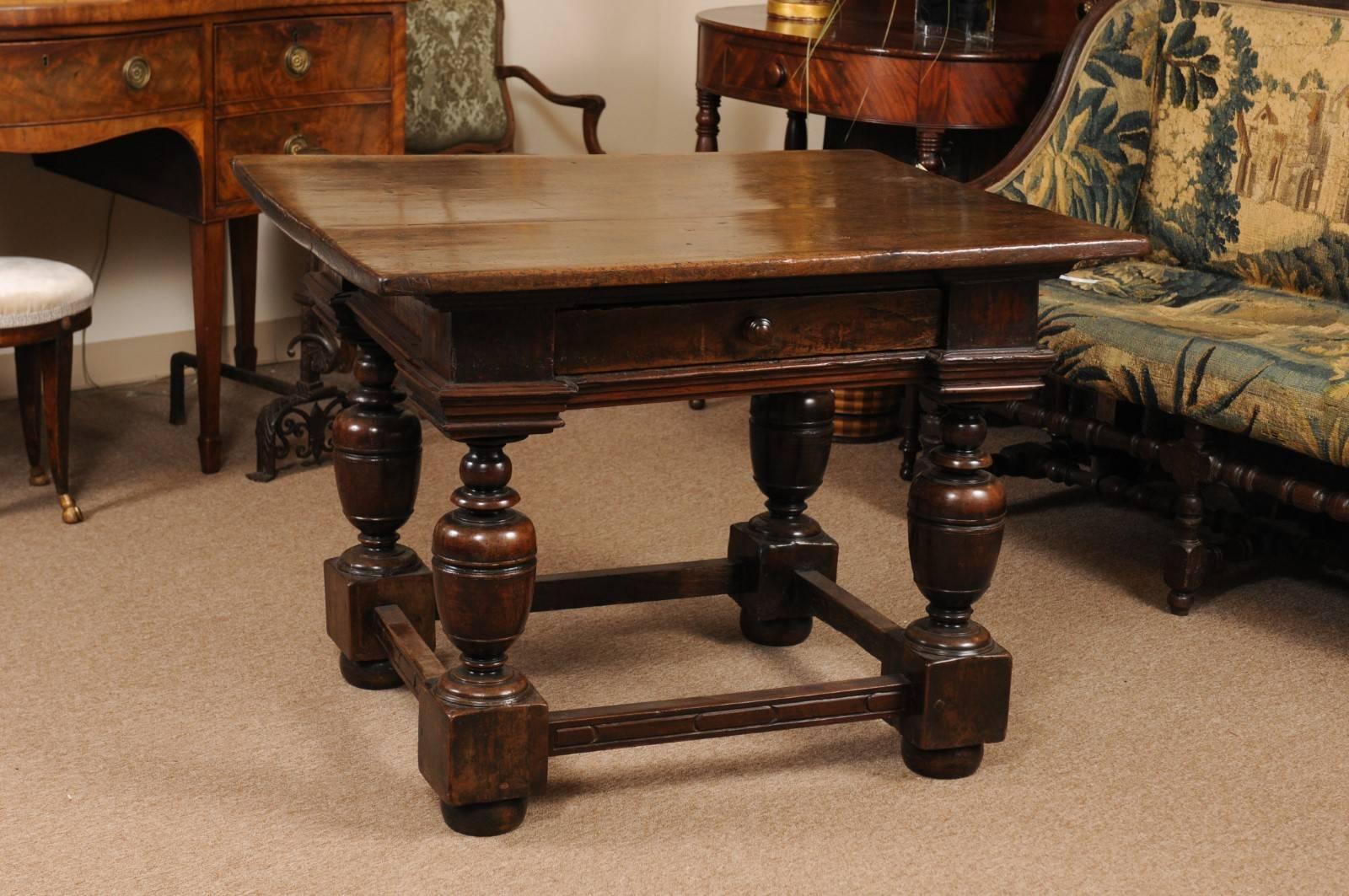The early 18th century Italian centre table with a one piece rectangle top. The frieze with large drawer and all supported by turned baluster legs with stretcher and bun feet. The table is a nice medium walnut.



       