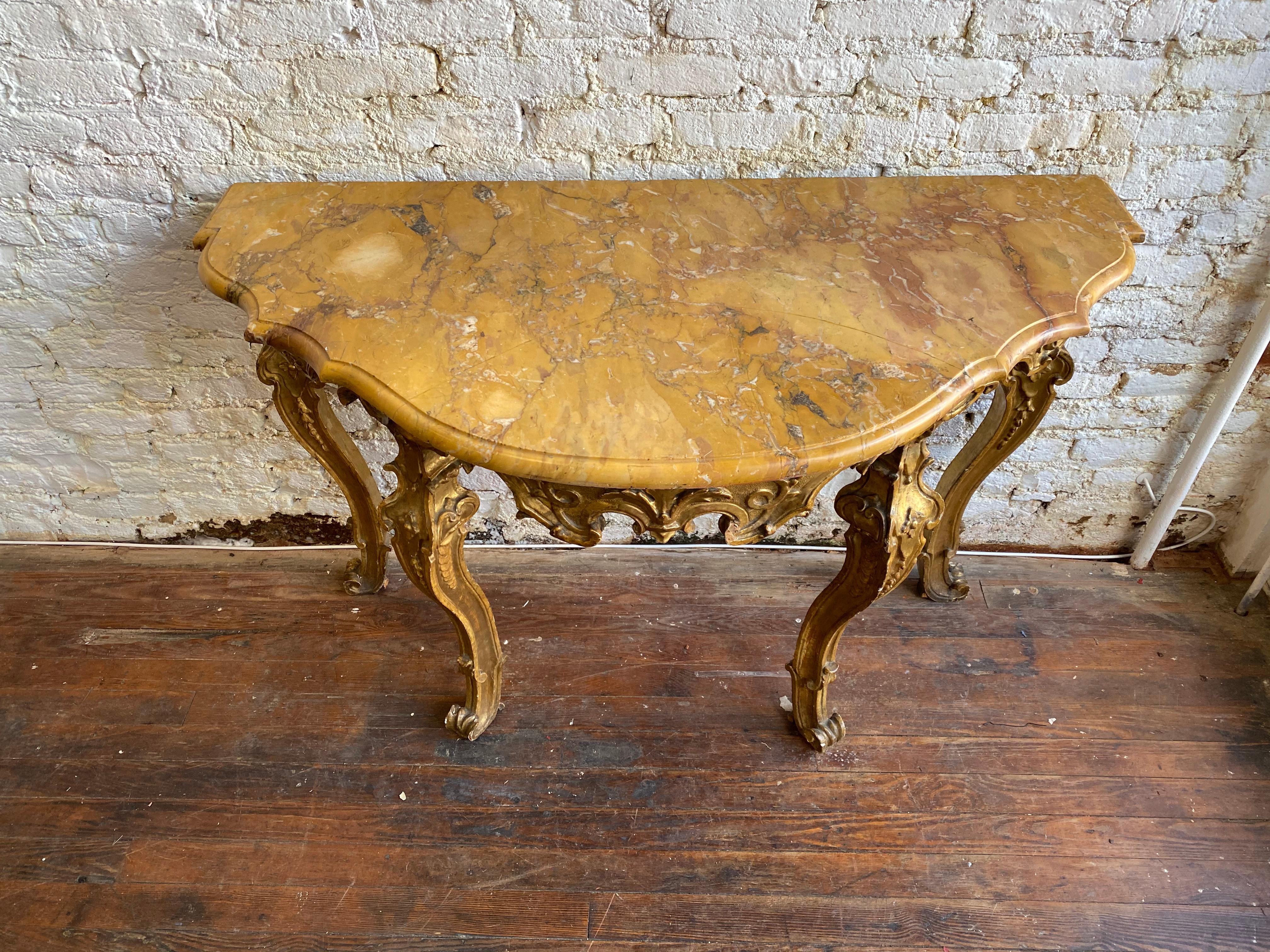 Wonderful early 18th century Italian Rococo giltwood console with Siena marble top. Free standing console with incredible quality carving. Price tag from the previous owner still in tact- $85,000.
