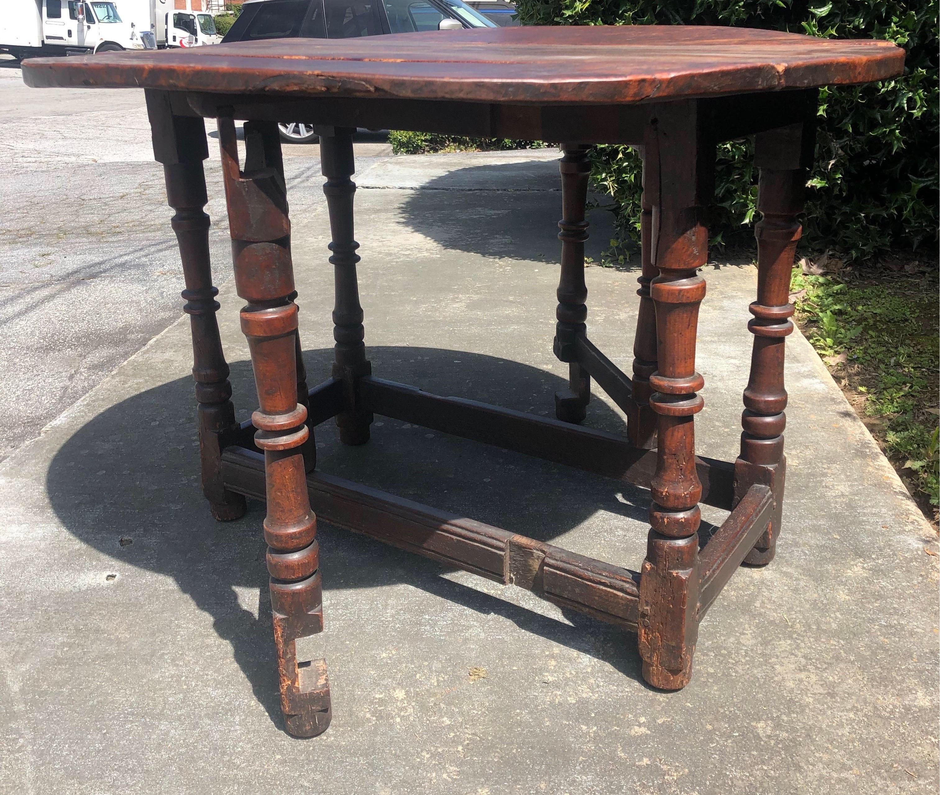 Early 18th century solid elm table with heavy three-plank top and ring turned legs. 300 years of use makes an incredibly beautiful patina throughout. 



Measures: 25