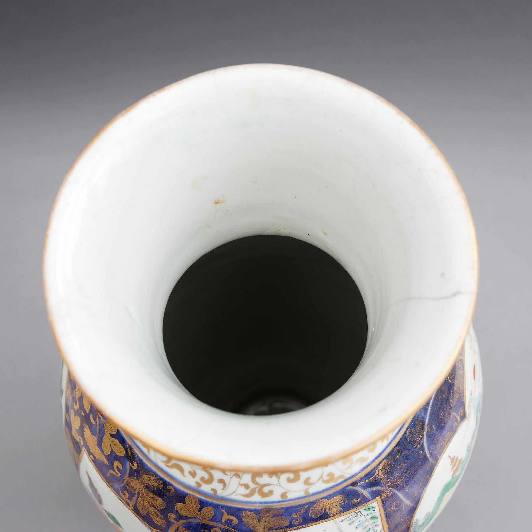 A rare Japanese late 17th-early 18th century Imari vase of beaker-type, porcelain of elongated ovoid shape with flaring neck, painted in the Imari palette of underglaze blue with overglaze iron-red and green enamel with details in gold. The dense