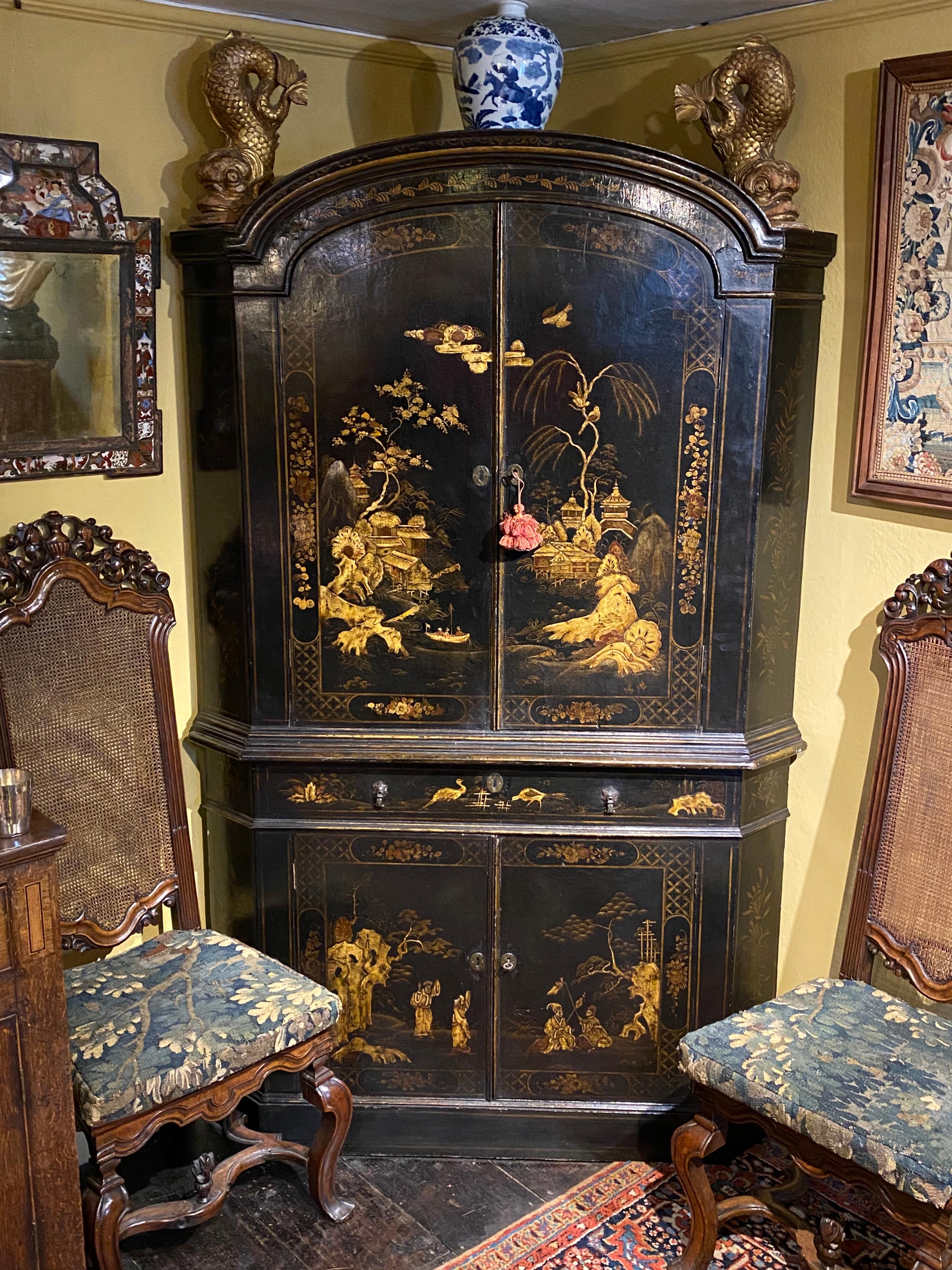A rare chinoiserie standing double corner cabinet, or cupboard.
English, George I period, ca 1720.

Often erroneously referred to as lacquer work, this is in fact japanned. Beautifully decorated with idyllic scenes of rockwork, pagodas, people,