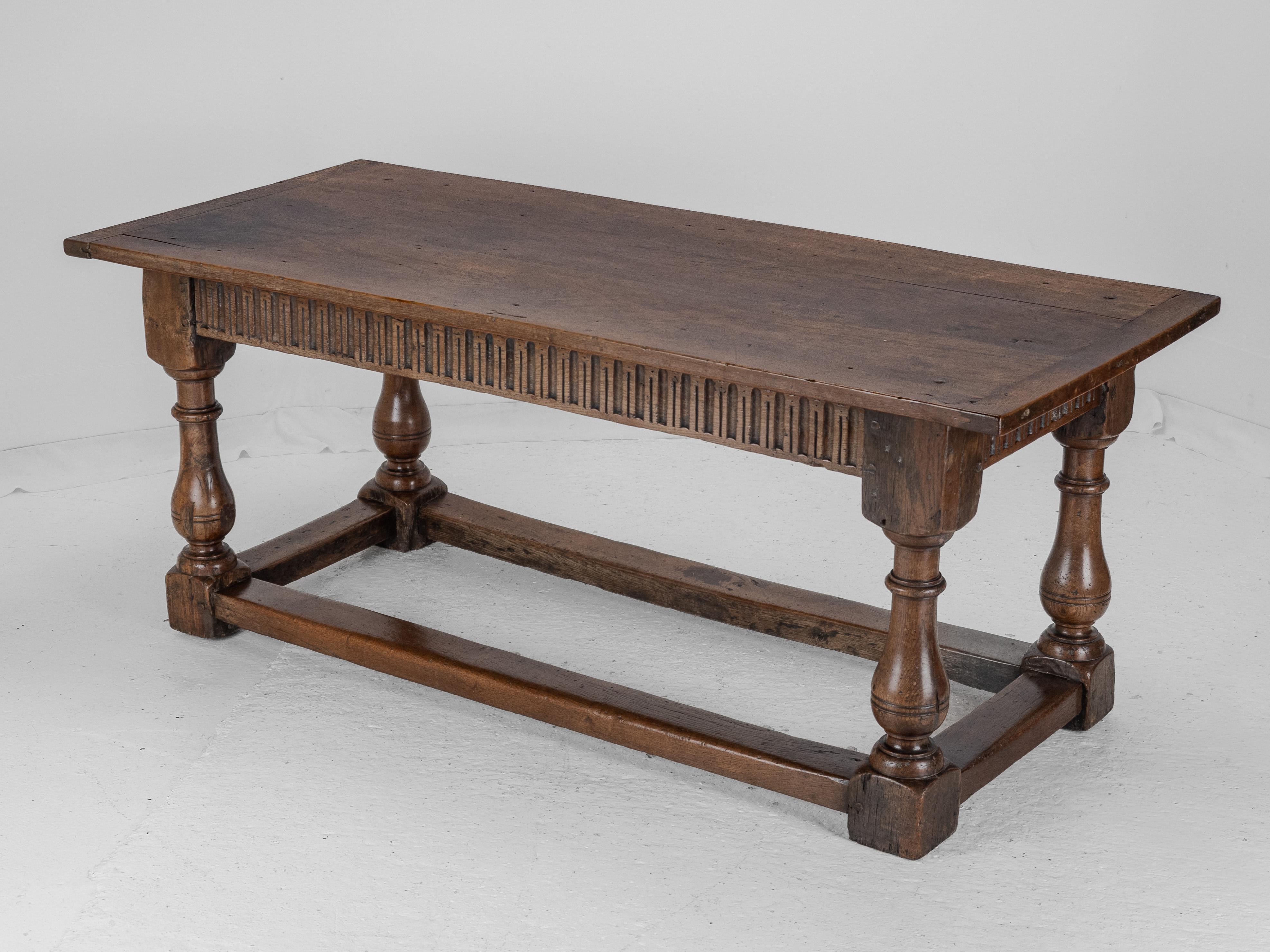 Early 18th Century Joined Oak Refectory Table

A fine and robust joined oak refectory dining table, early 18th century, England. The table features a wide three-plank top, approximately 183 cm in length, with a rich, golden-brown patina developed