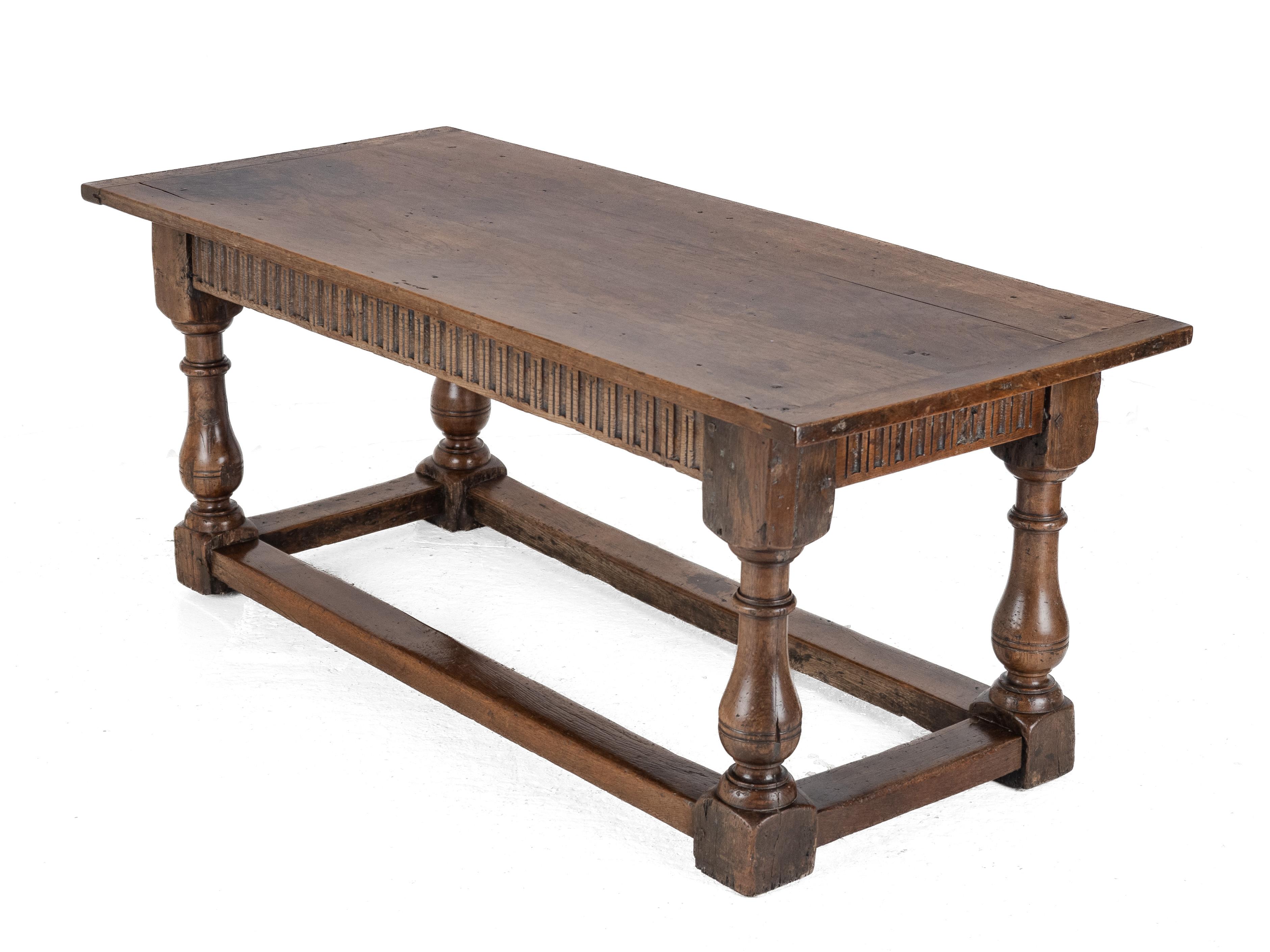 Early 18th Century Joined Oak Refectory Table

A fine and robust joined oak refectory dining table, early 18th century, England. The table features a wide three-plank top, approximately 183 cm in length, with a rich, golden-brown patina developed