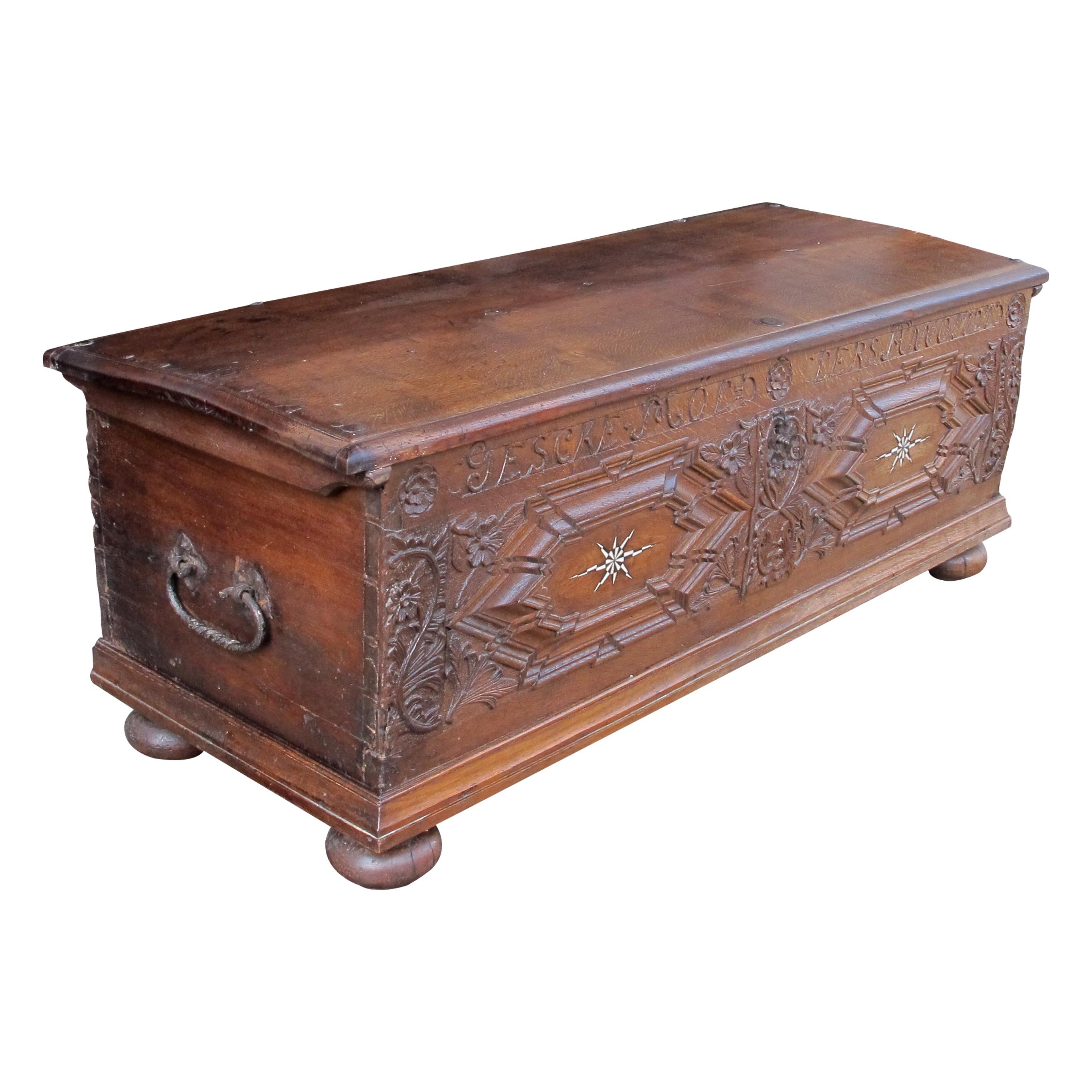 This 1727 oak trunk is of magnificent craftsmanship, showcasing intricate carvings and exquisite attention to detail. Crafted from solid oak, the trunk is sturdy and substantial, reflecting the robustness and durability characteristic of furniture