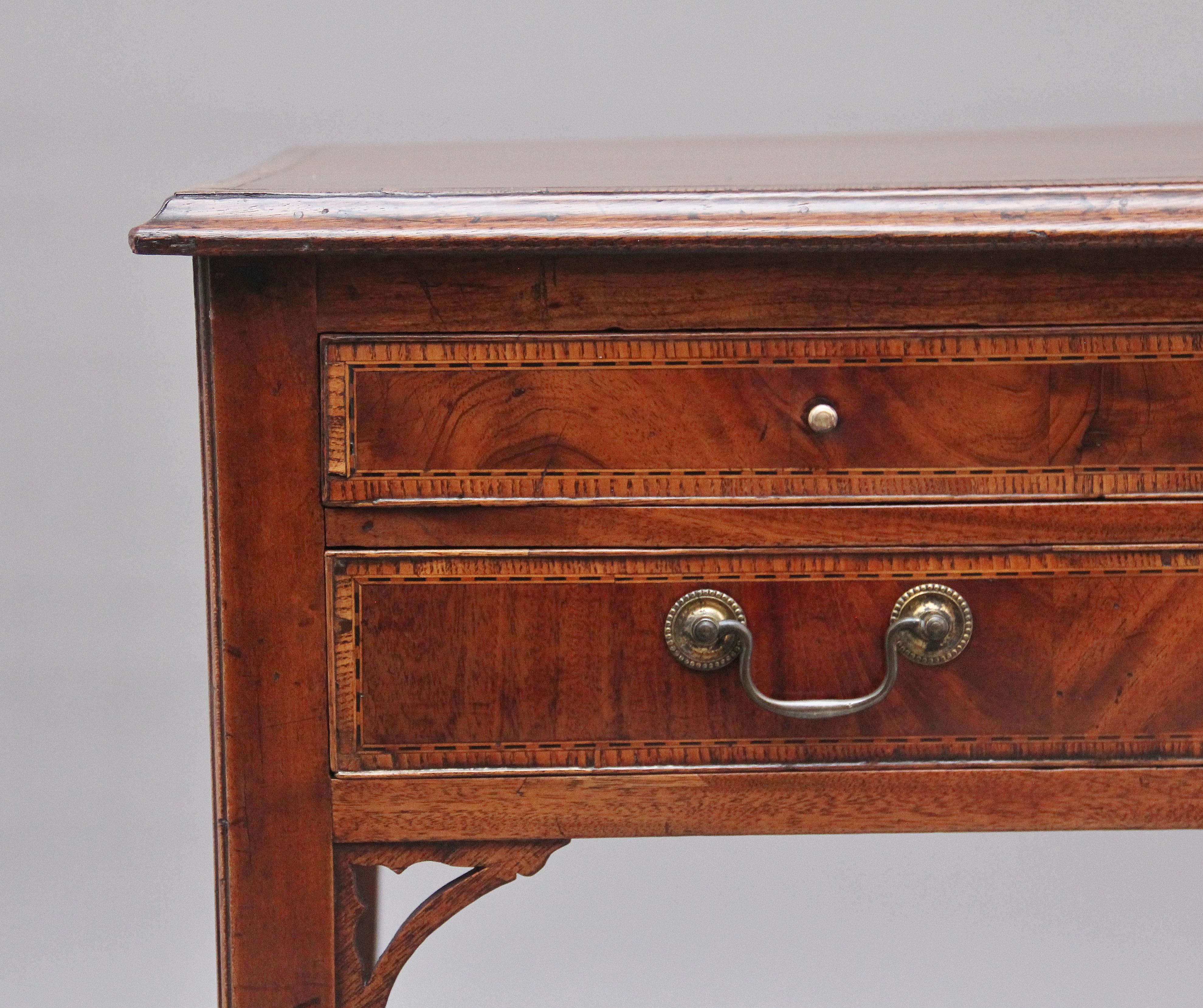 Early 19th century mahogany side table, having a crossbanded moulded edge top above two short over one long drawers with original brass swan neck handles, the drawer fronts having decorative crossbanding, supported on square legs with shaped corner