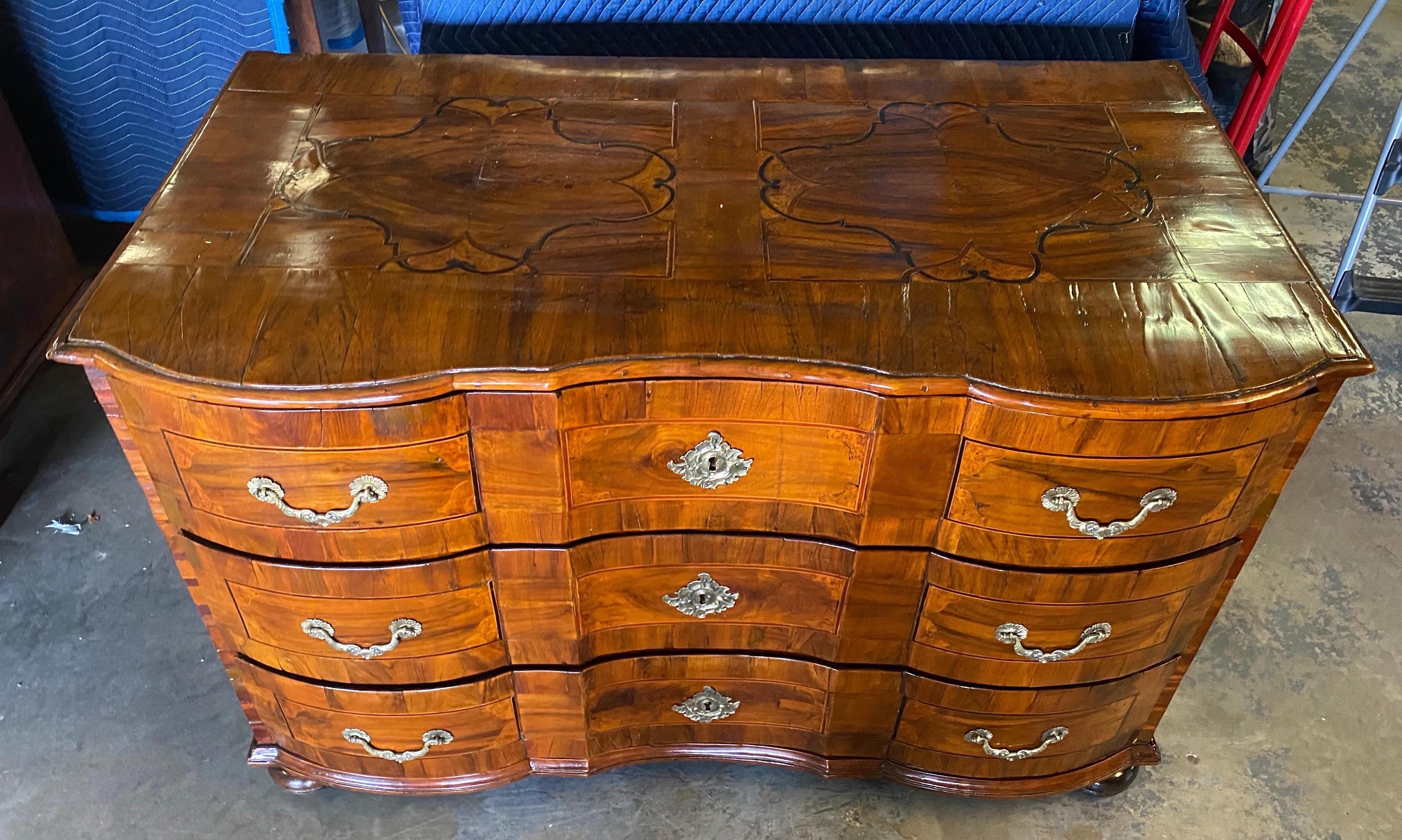 Incredible early 18th century Northern Italian 3-drawer walnut commode with ebony and parquetry inlay and bun feet. Wonderful color and patina.
 