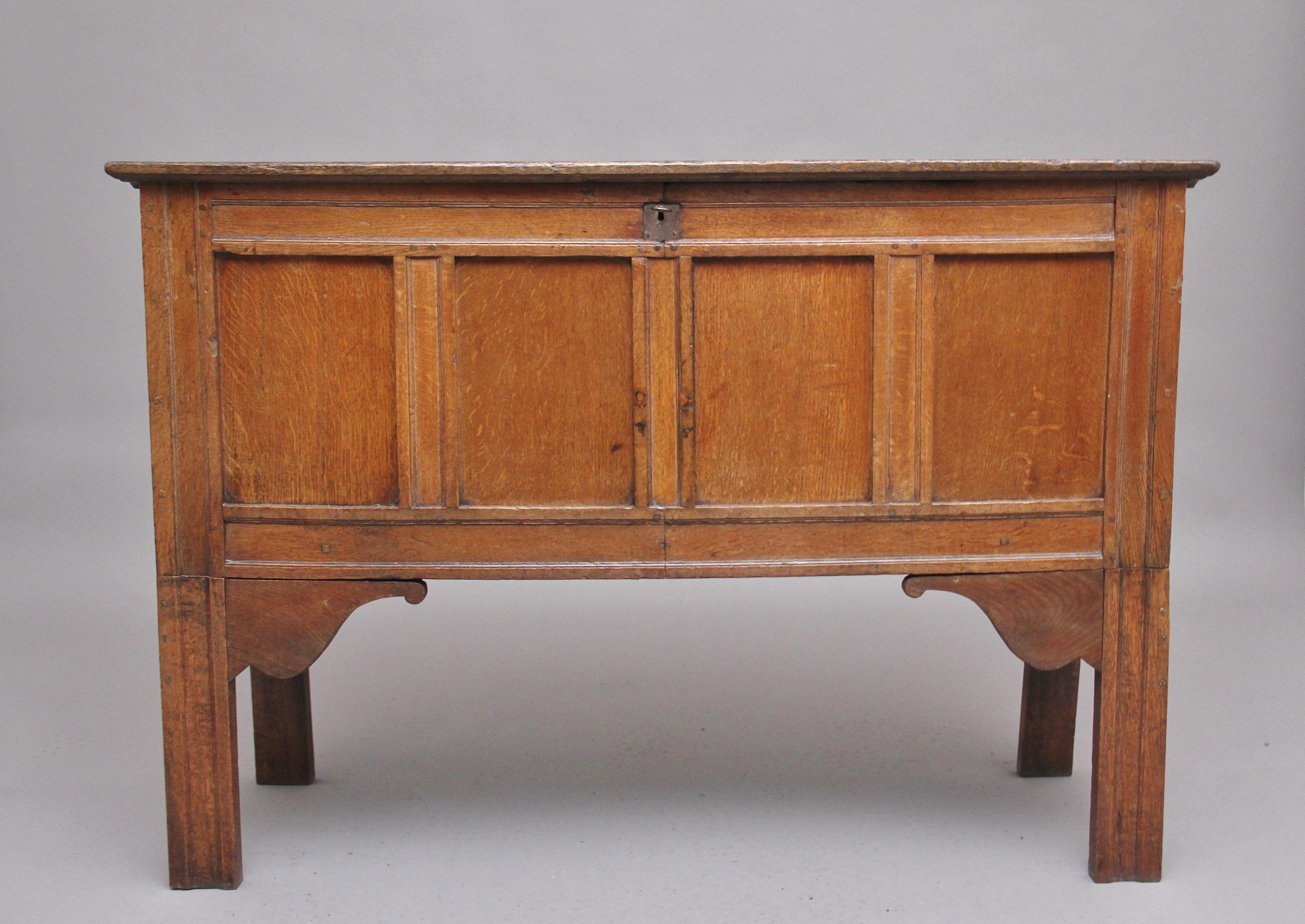 Early 18th century oak coffer with a wonderful figured top that lifts up to reveal a large compartment space, having a four panelled front with moulded edge, supported on moulded square legs with front shaped corner brackets. Circa 1740.