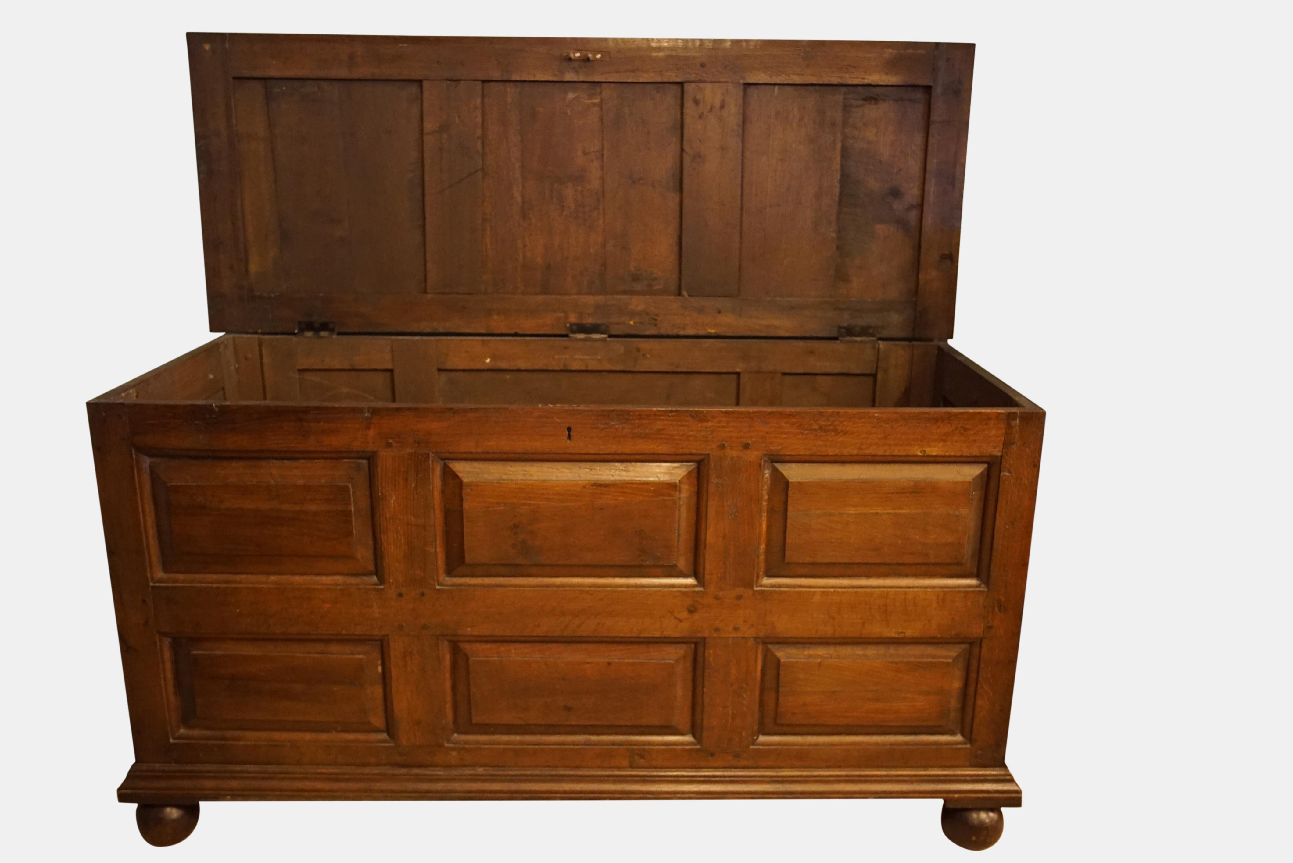 A large early 18th century oak coffer with three-panels to the top and six-panel front standing on bun feet.

circa 1740.