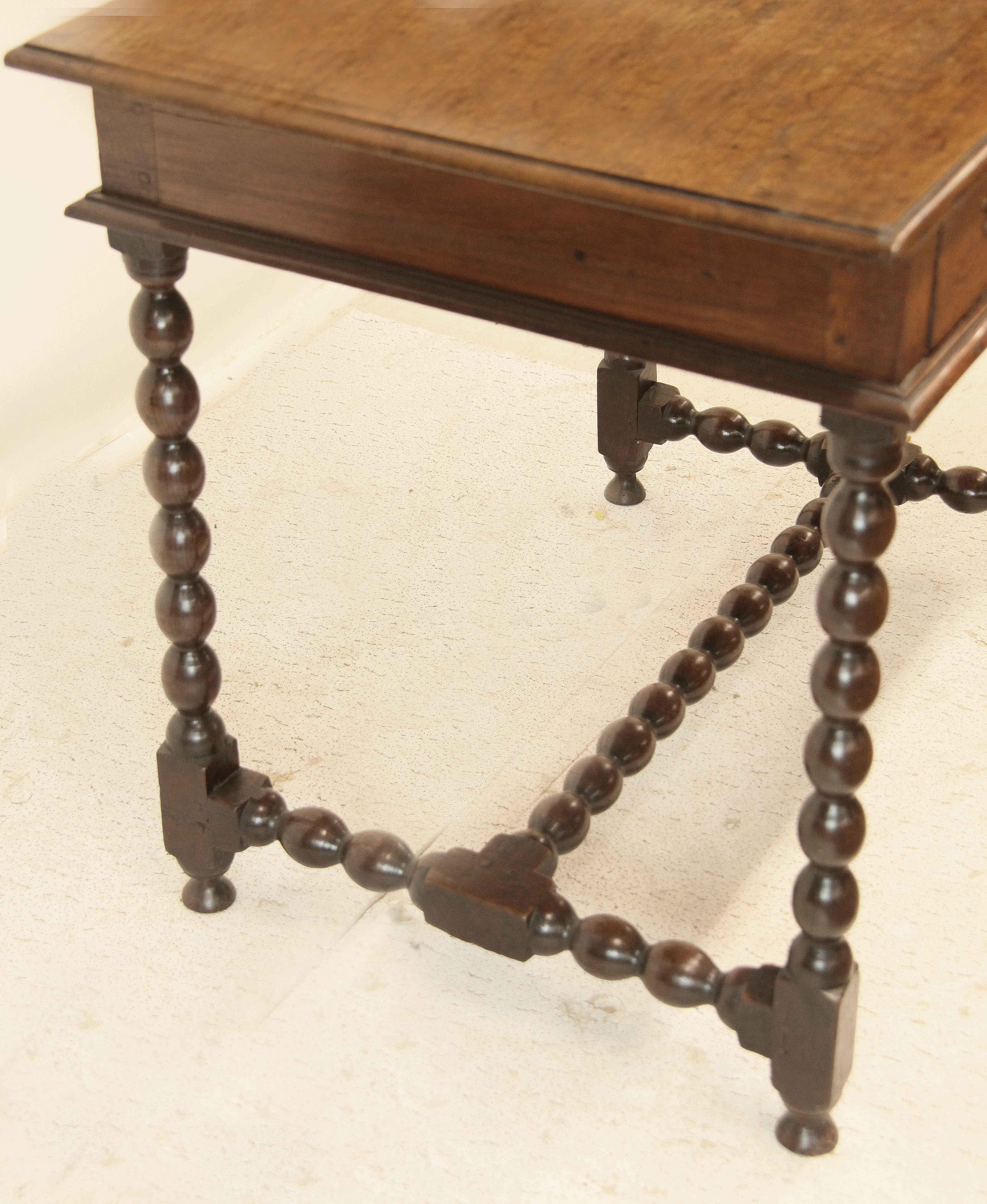 Early 18th century oak one drawer table, the top with molded edge all around, single drawer with etched brass pulls and escutcheon( not original but hand made and correct for the period). The legs and connecting stretchers with bobbin turnings,
